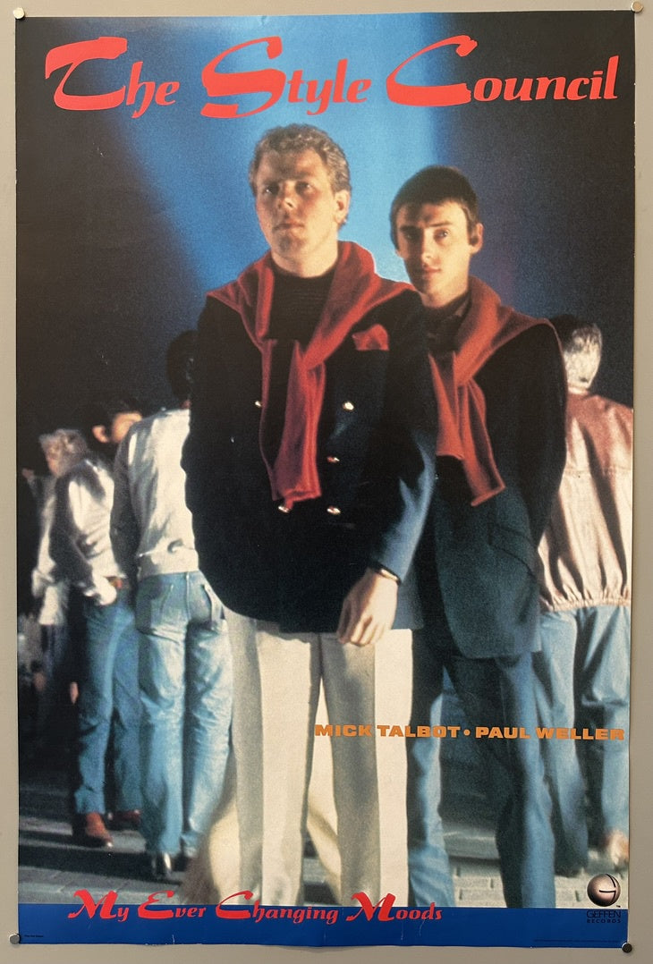 A vintage promotional poster for The Style Council's single "My Ever Changing Moods," featuring Paul Weller and Mick Talbot. The top of the poster has "The Style Council" in large red script, and the bottom features "My Ever Changing Moods" in similar red script