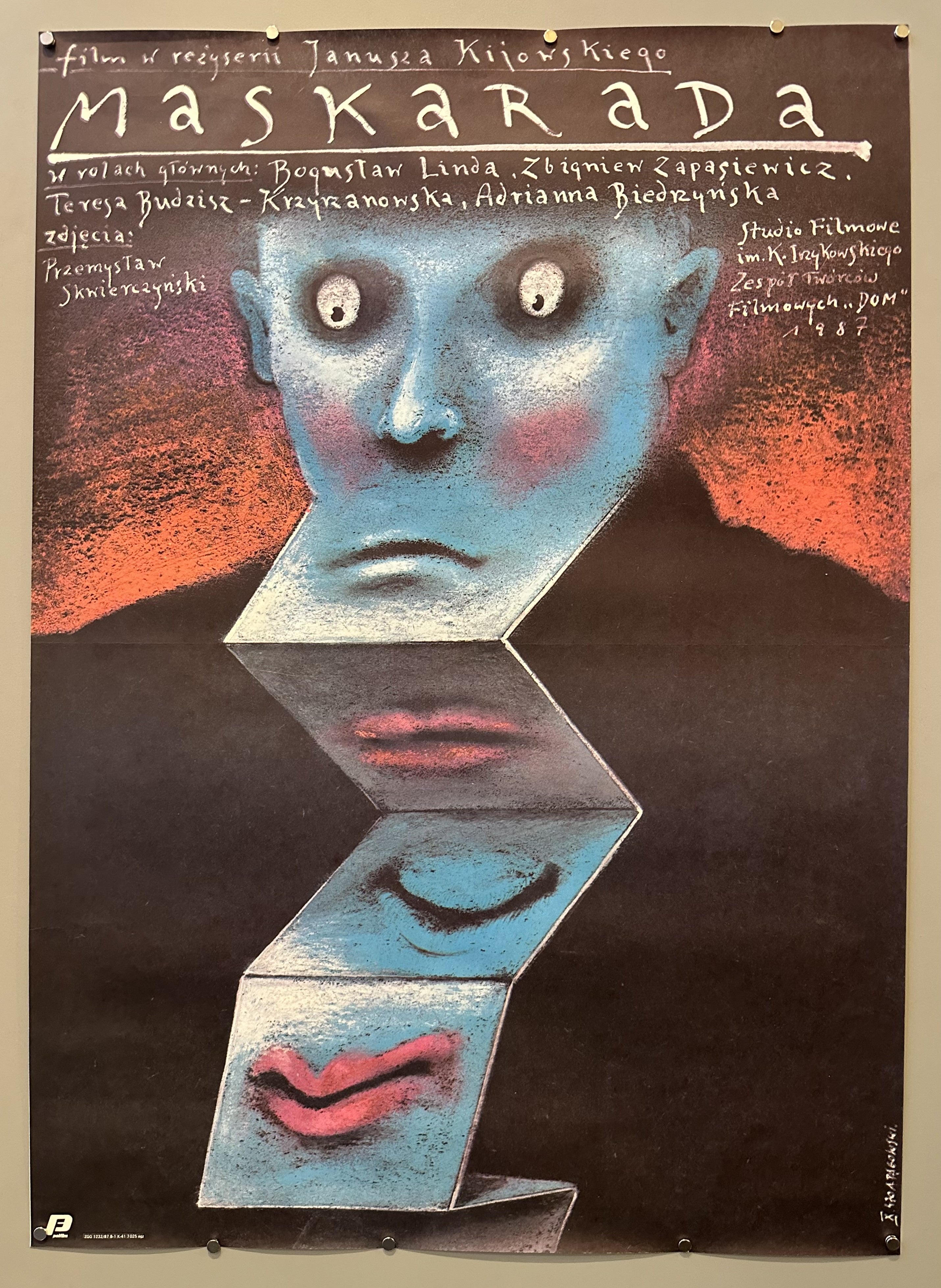 face of a blue person with its chin connected to mirrors with different emotions. Surrounding the face is text about the film.