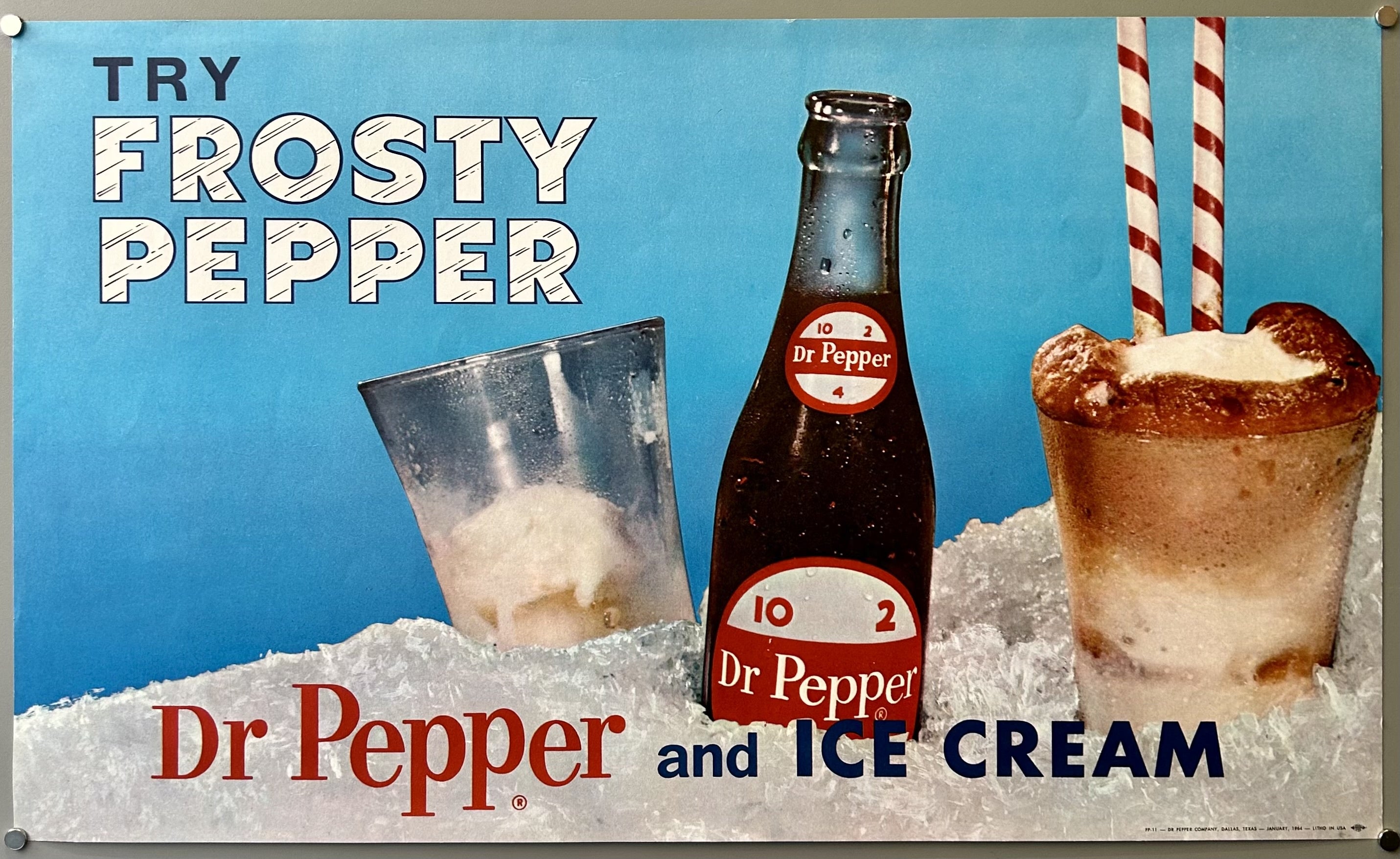 Dr. Pepper soda stuck in ice with a frosted glass and a root beer float next to it against synthetic bright blue background.