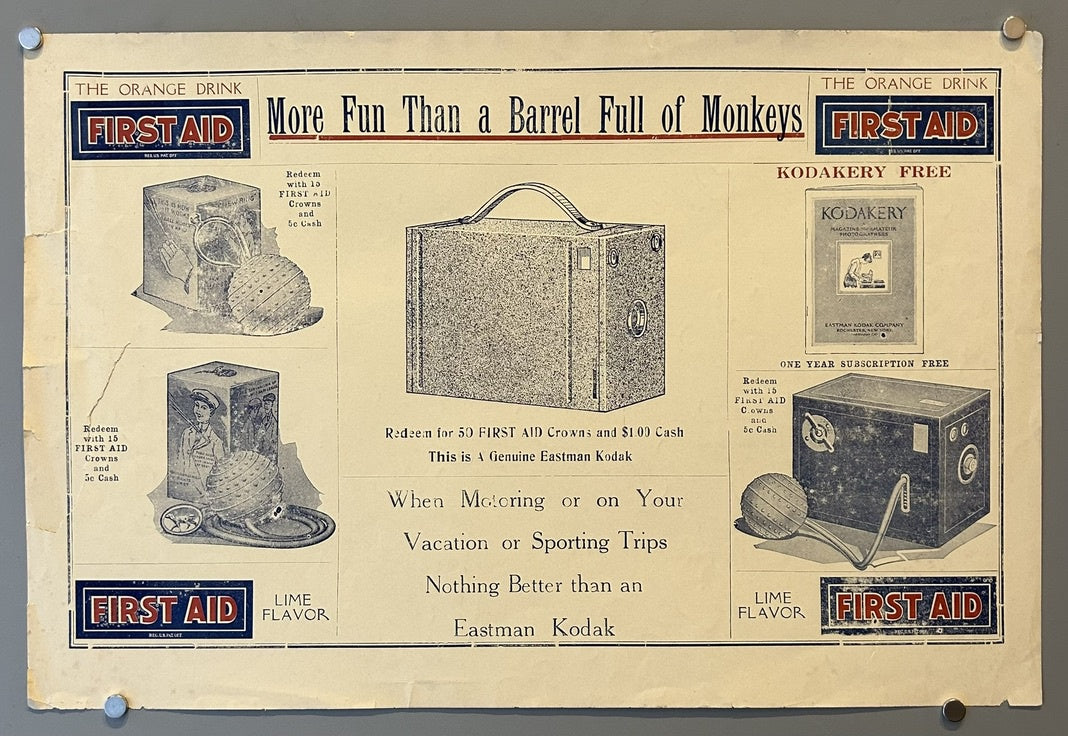 This is a vintage advertising poster for First Aid brand orange and lime drinks, promoting a contest to redeem bottle caps for an Eastman Kodak camera. The poster features images of the camera and other premiums, with the slogan "More Fun Than a Barrel Full of Monkeys."