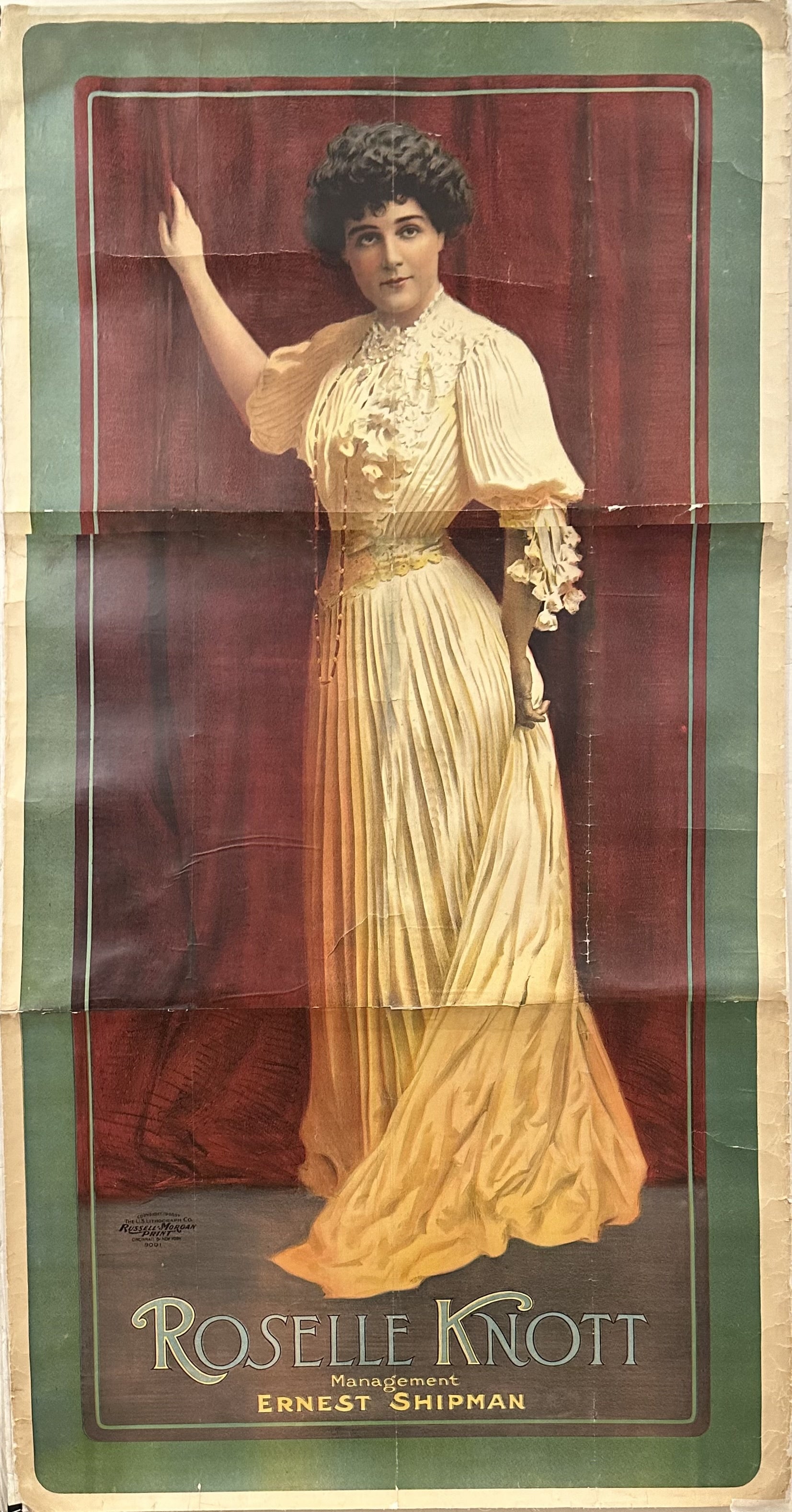 A vintage portrait featuring actress Roselle Knott in a theatrical pose. She is wearing a white dress with lace details and her arm is extended gracefully. The text reads 'Roselle Knott, Management Ernest Shipman.'".