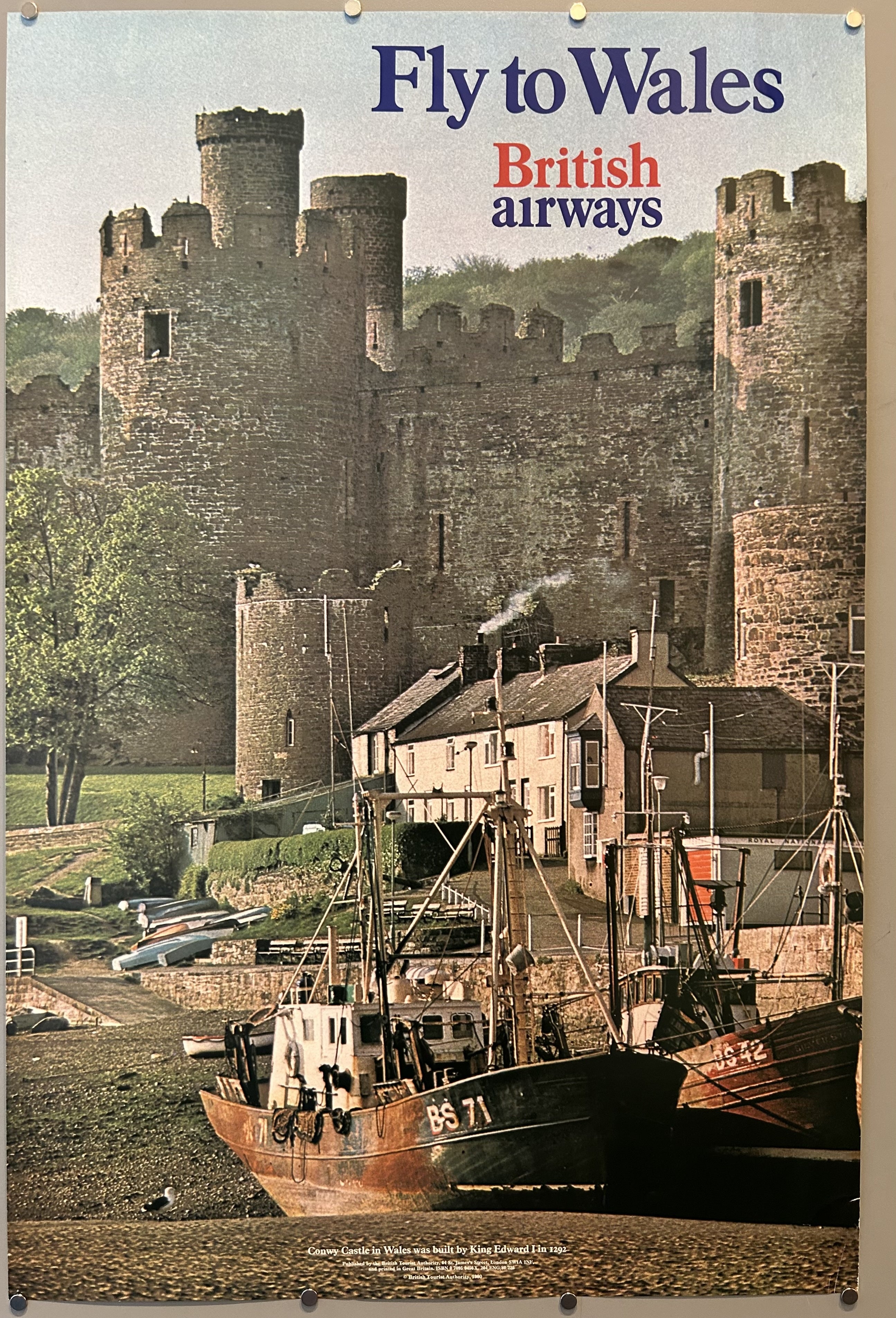 This vintage travel poster, promoting "Fly to Wales" with "British Airways" and featuring Conwy Castle, is identified as being published in 1