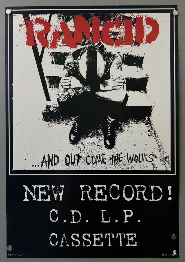 The poster features the band name "RANCID" prominently at the top and the album title "...AND OUT COME THE WOLVES" below the central image.