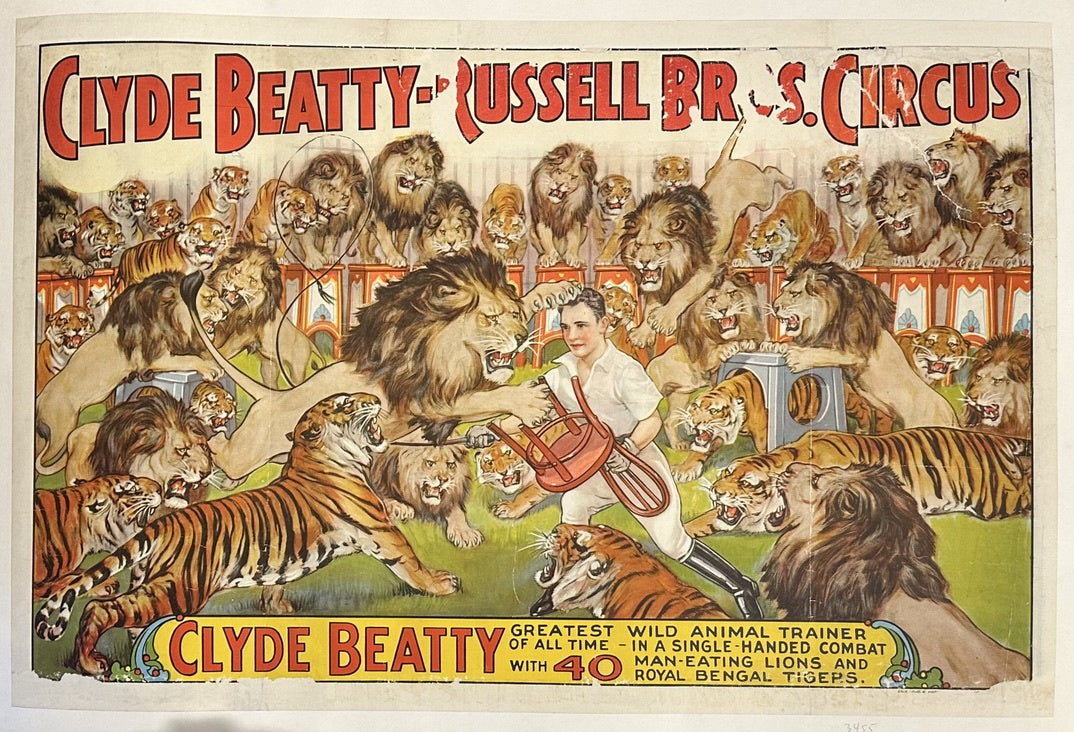 The poster prominently features Clyde Beatty, known as the "Greatest Wild Animal Trainer of All Time," in a dynamic scene where he appears to be in "single-handed combat with 40 Man-Eating Lions and Royal Bengal Tigers". He is depicted holding a chair and whip, facing multiple large cats.