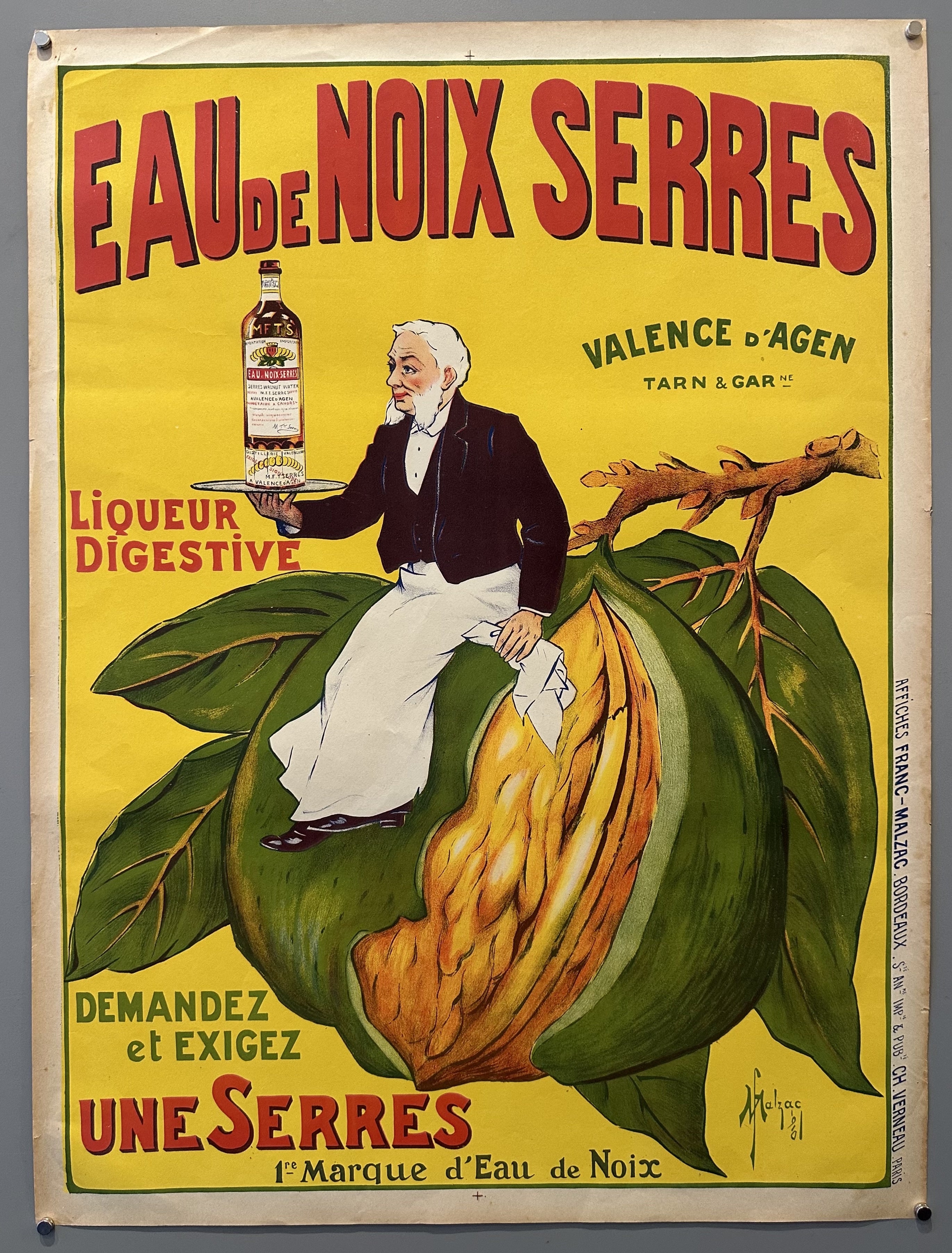 Man sits on a green walnut holding a bottle of Eau De Noix Serres in vintage advertisement for French liqueur.