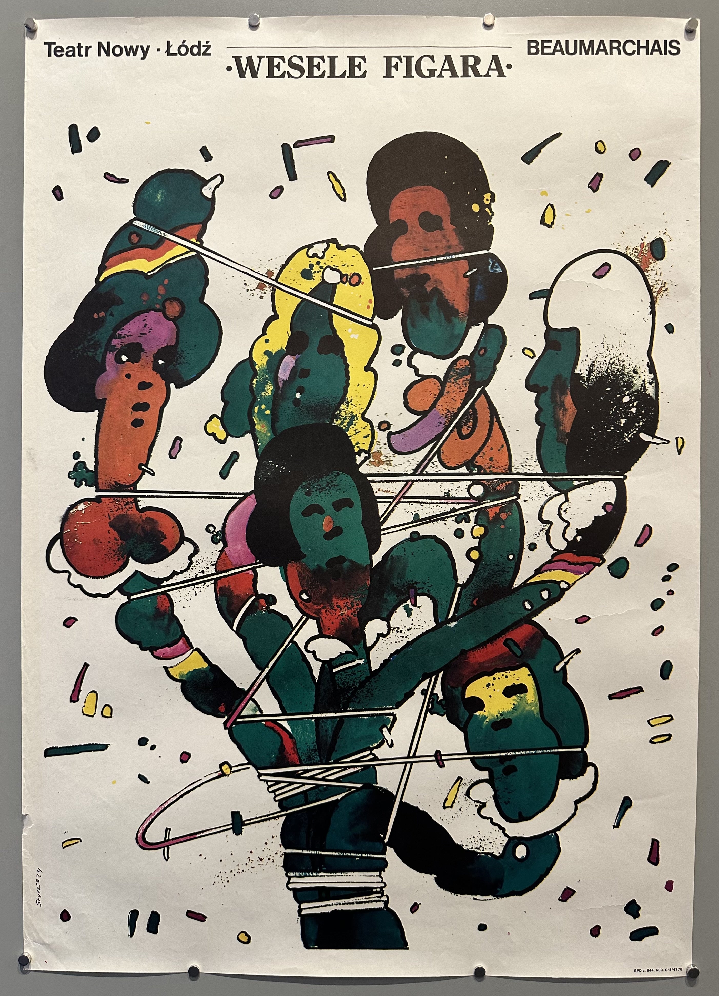 A poster featuring abstract figures with colorful faces and bodies entangled in lines, advertising "The Marriage of Figaro" at Teatr Nowy in Lodz.