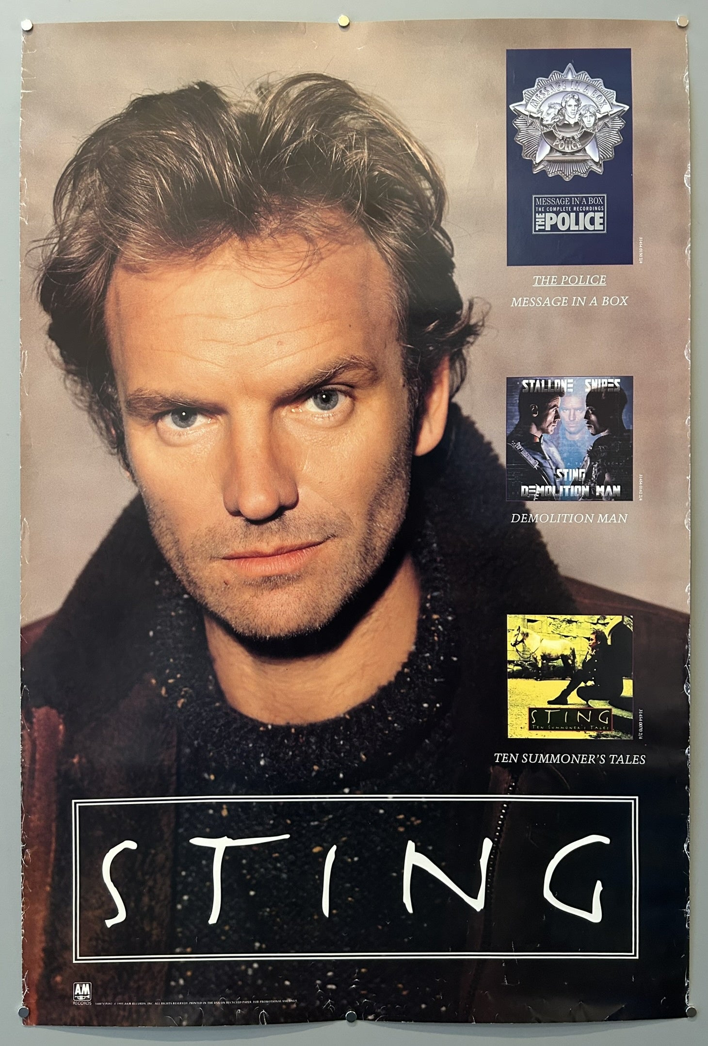 A promotional poster featuring Sting, with a large central image of his head and shoulders. The poster includes smaller images and text promoting "The Police: Message in a Box" and "Sting: Demolition Man," and "Sting: Ten Summoner's Tales."