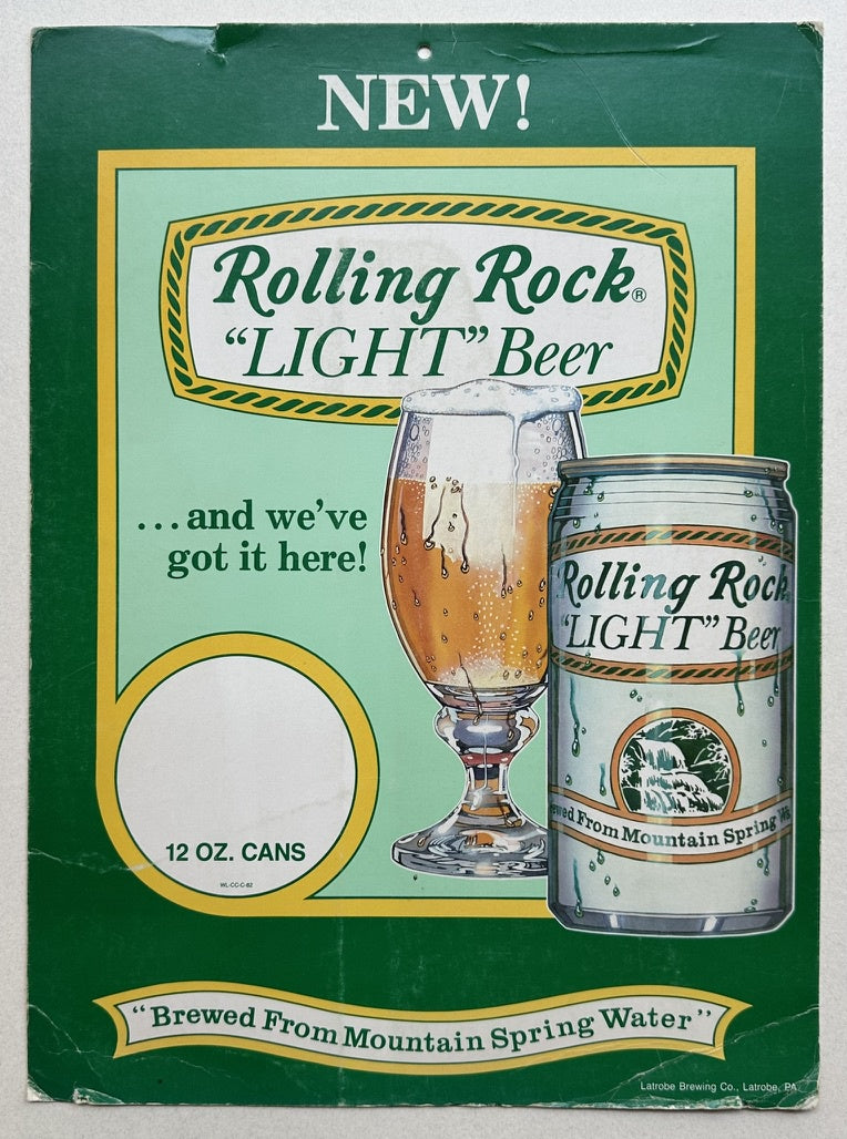 This poster advertises Rolling Rock "LIGHT" Beer, highlighting it as a new product. It features a glass of the beer alongside a can, emphasizing that it is "Brewed From Mountain Spring Water."
