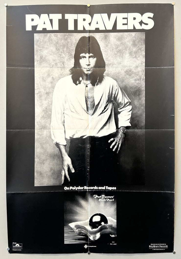 A black and white promotional poster for the musician Pat Travers and his album "Black Pearl." The poster features a large central image of Pat Travers, a man with long hair and an open-collared shirt, looking directly at the viewer.