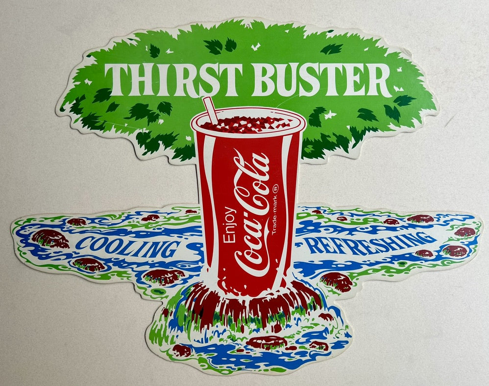 This poster features a vibrant image of a Coca-Cola cup overflowing with the beverage, placed against a backdrop of green foliage and blue water