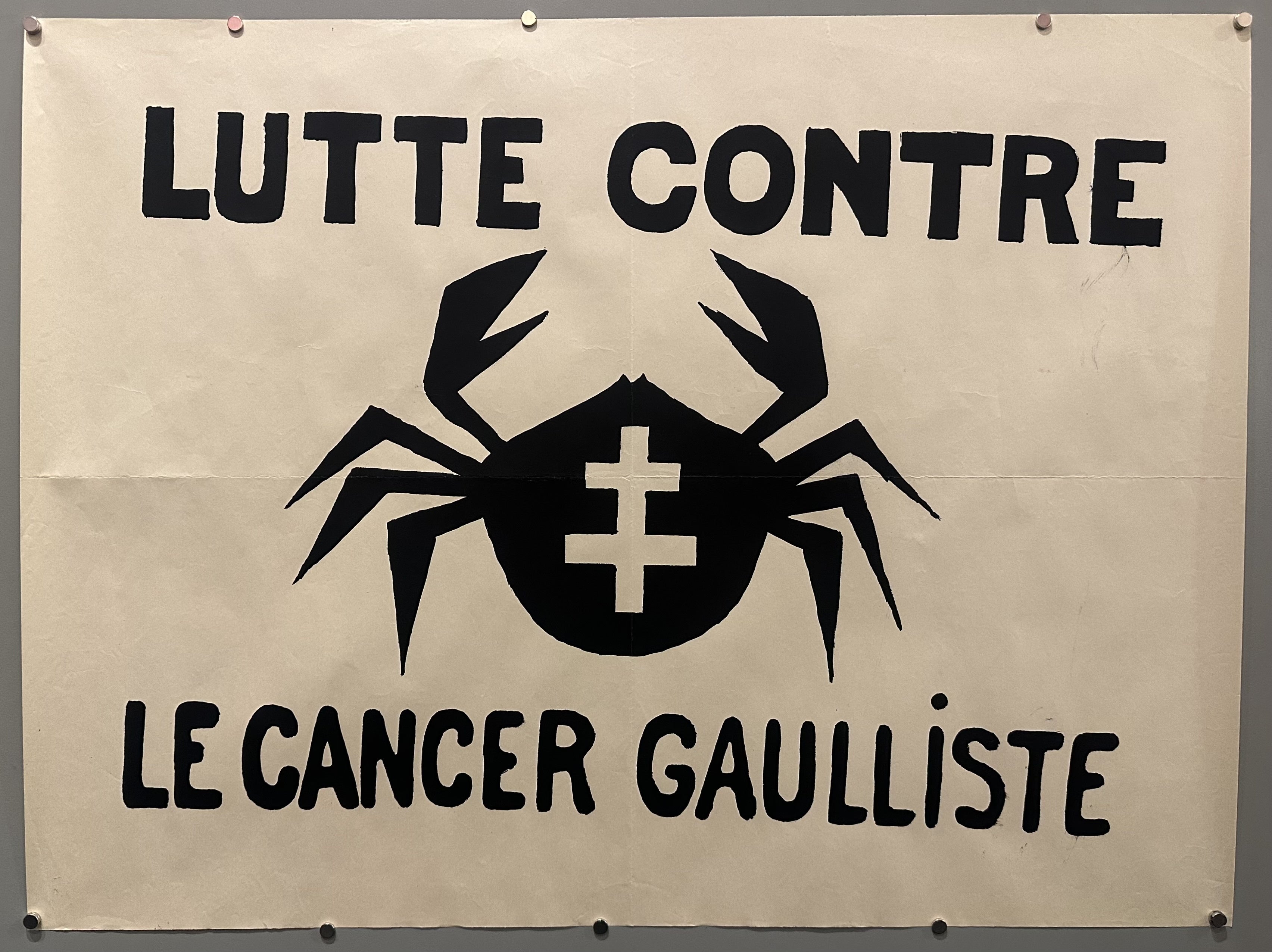 A crab with the Cross of Lorraine on its shell is in the middle with black text above and below it.