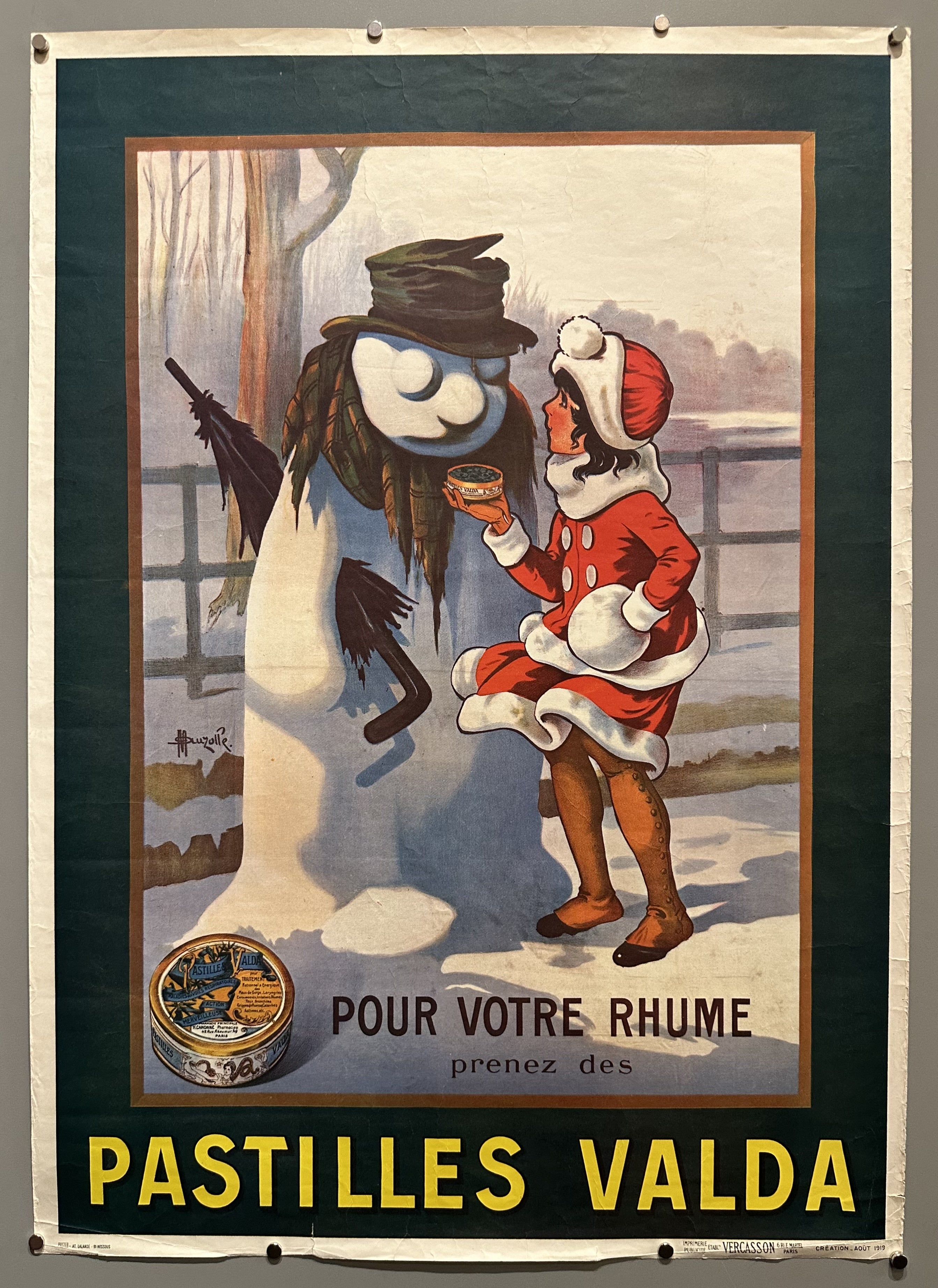 A young girl offers a snowman a cough drop in this French advertisement.