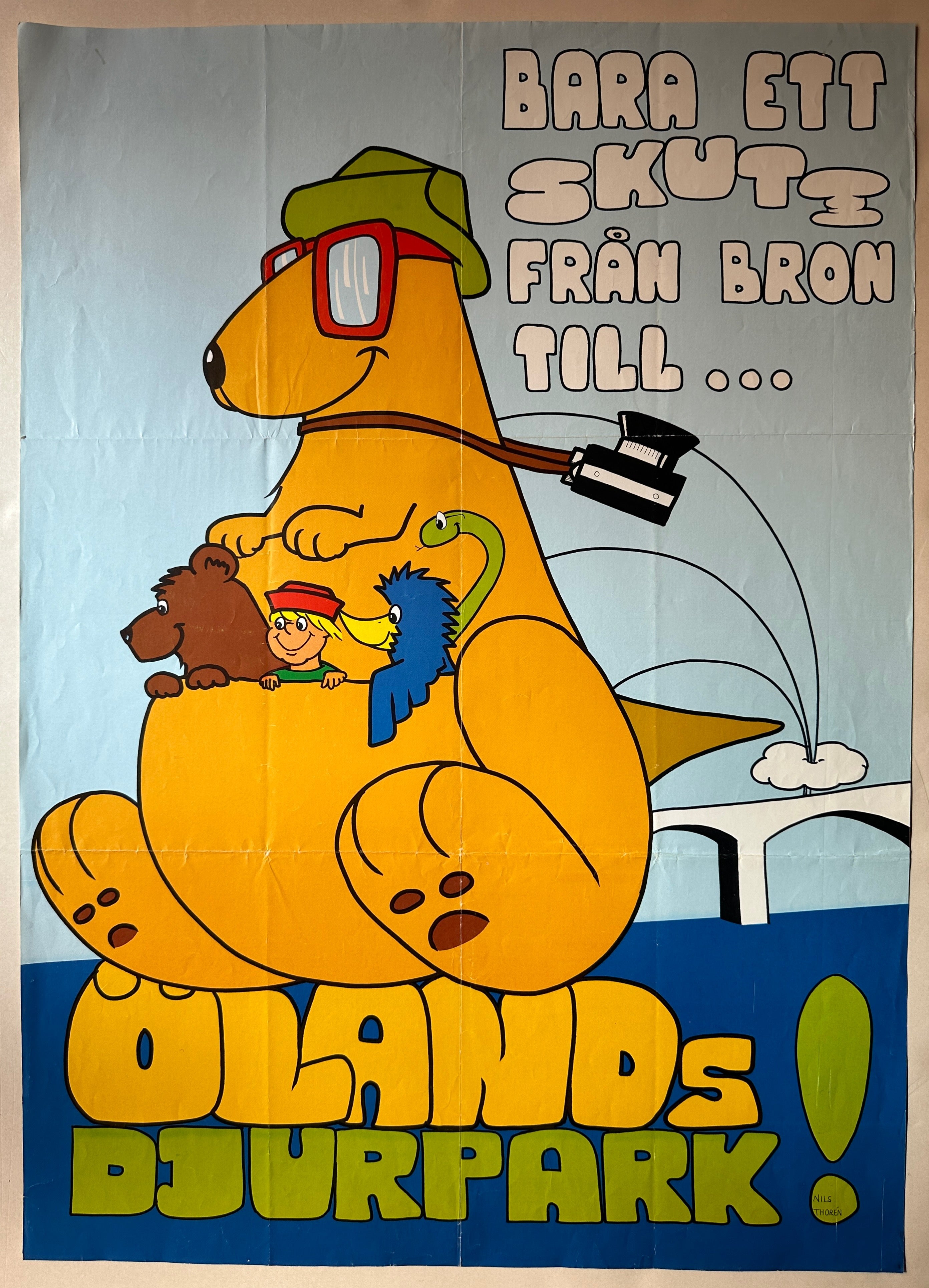 Vintage poster featuring a colorful kangaroo with a hat and glasses, carrying a young boy and three zoo animals in its pouch. The background displays a blue sky, a bridge, and a green field.