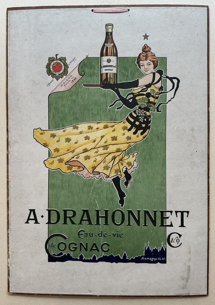 A woman in a yellow dress holding a bottle of cognac on a tray, set against a green background. The poster is designed in a classic Art Nouveau style, with flowing lines and elegant typography.