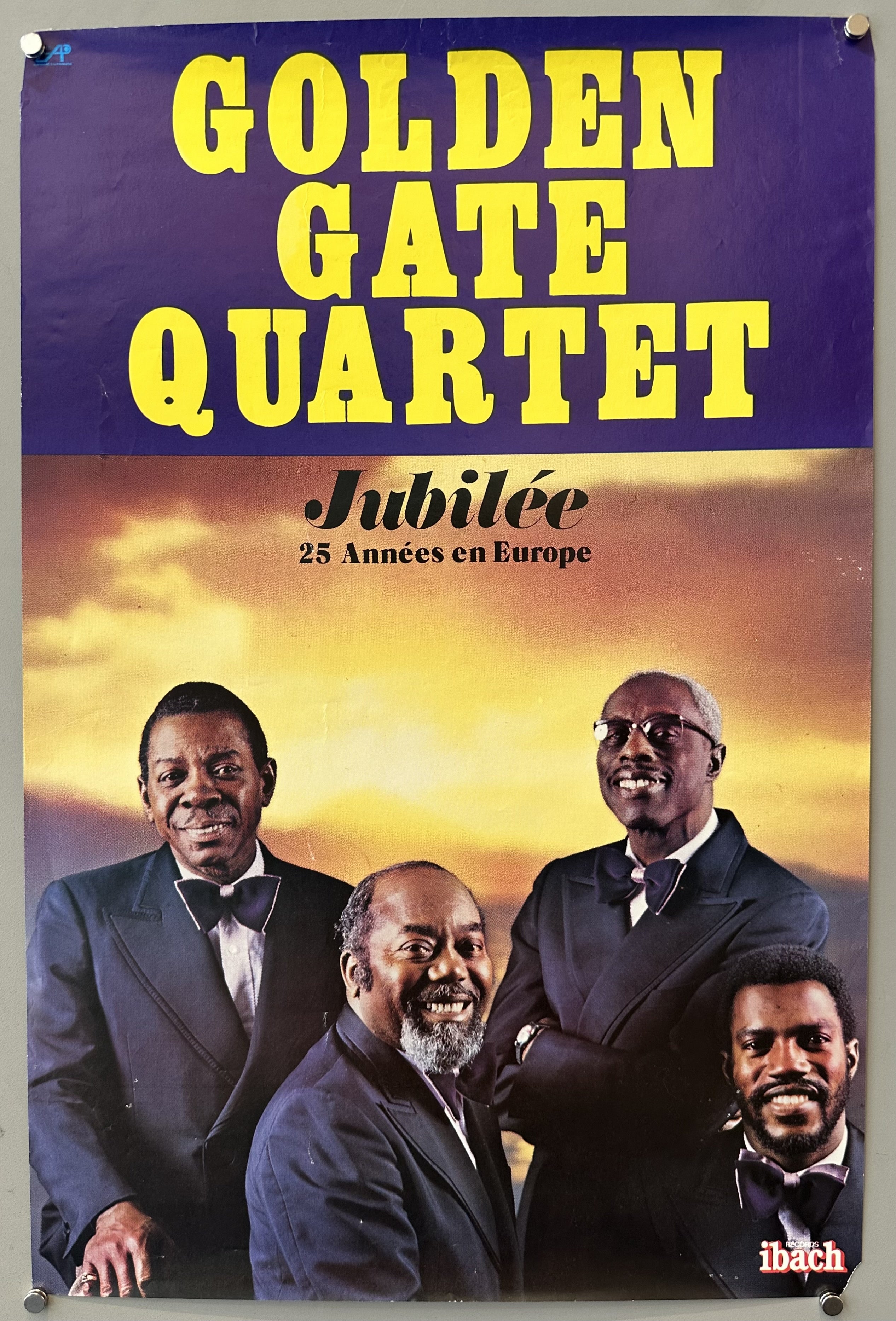 The four Golden Gate Quartet members stand together against a sunset background.