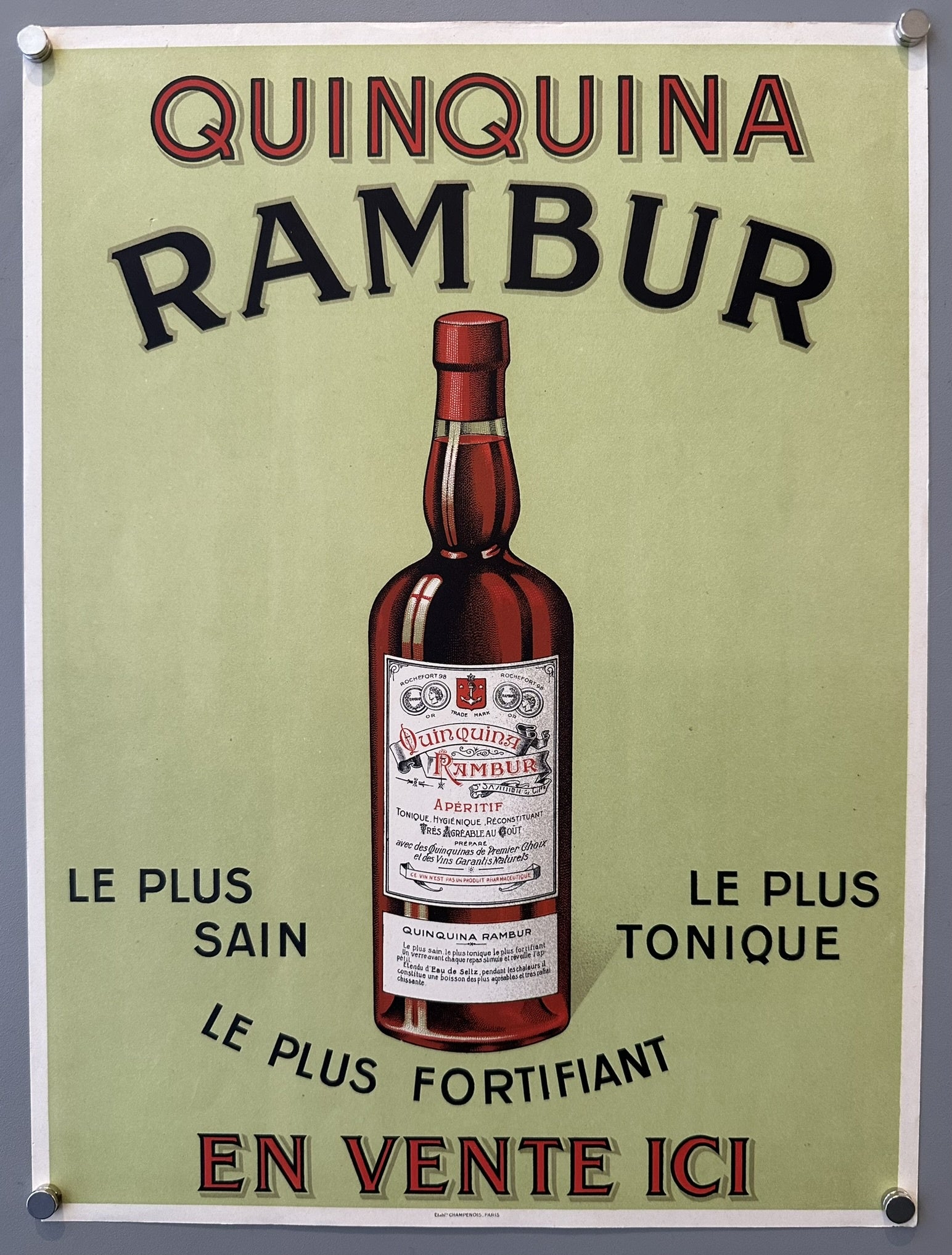 This poster is an ad for Quinquina Rambur, an aperitif wine that contains cinchona bark which provides quinine. The poster uses Art Deco style.