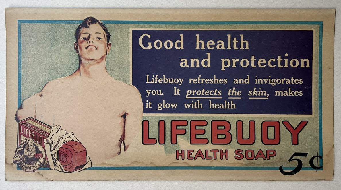 An antique advertisement for Lifebuoy Health Soap, featuring a strong, bare-chested man on the left. To the right, a dark blue rectangular panel contains text: "Good health and protection / Lifebuoy refreshes and invigorates you. It protects the skin, makes it glow with health".