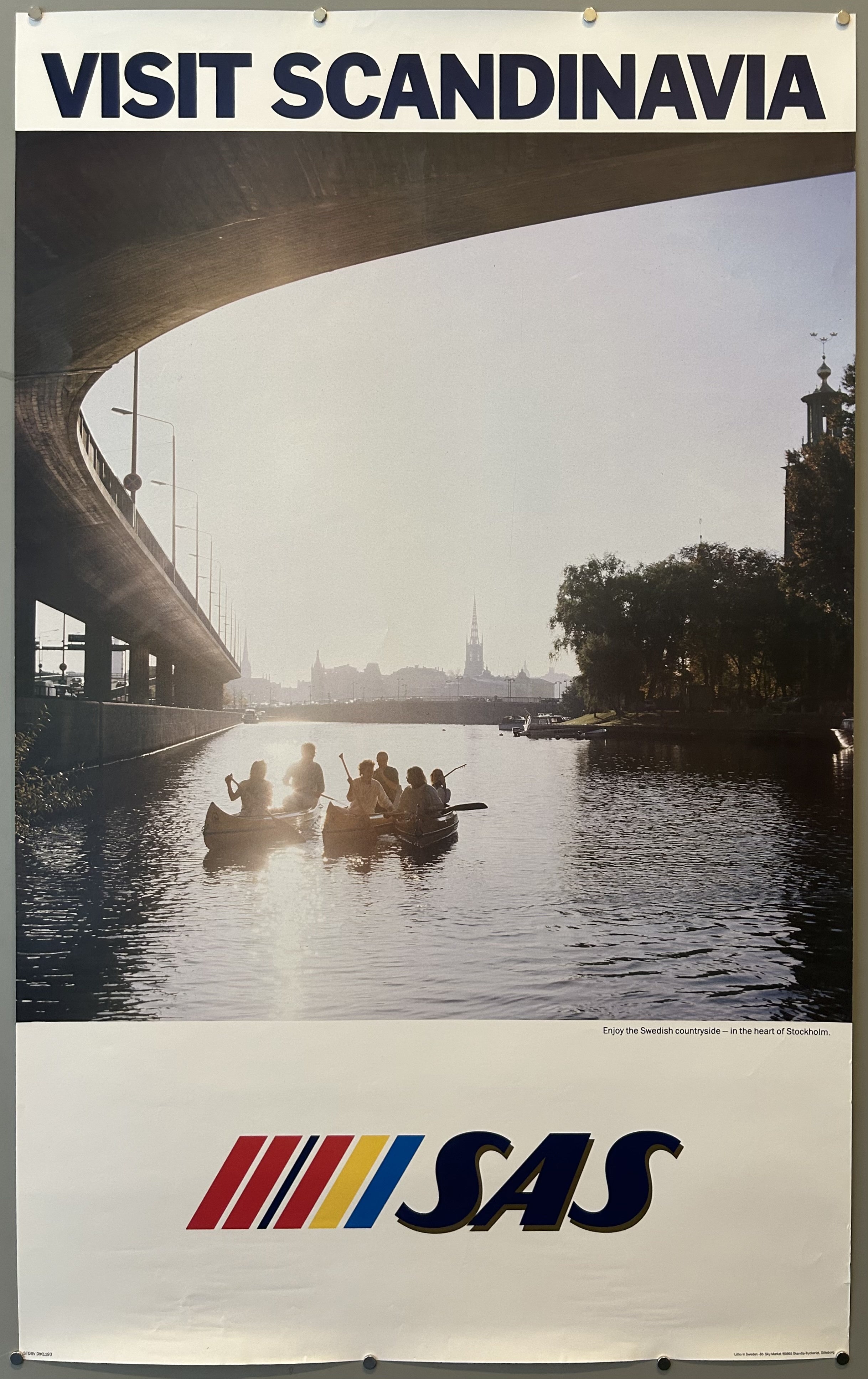 Photo of people rowing three boats along canal in Stockholm in vintage travel poster from SAS, text along top and bottom against white border.
