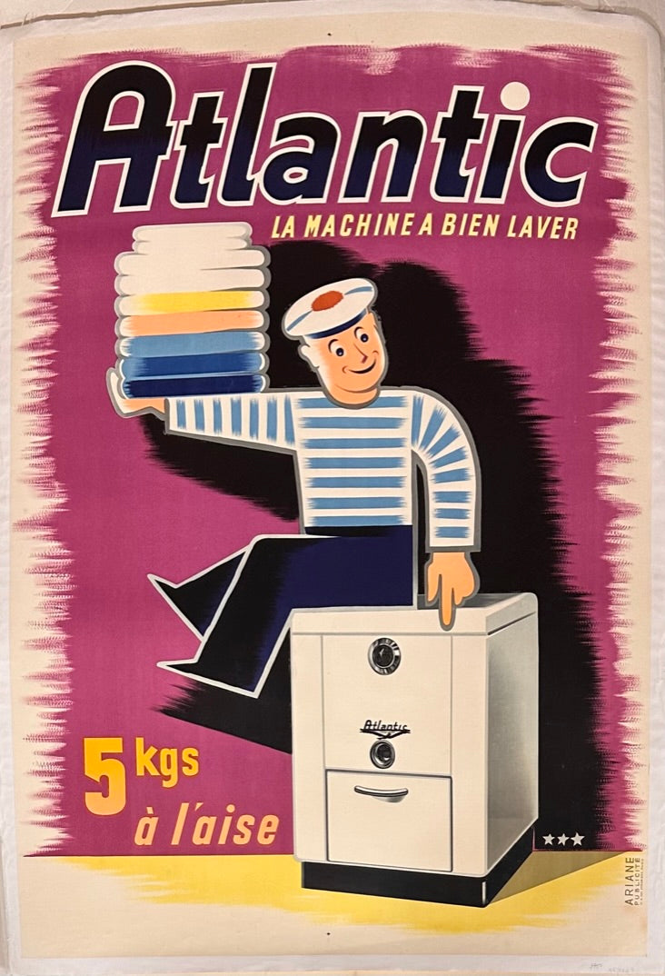 Man sitting on top of a laundry machine,  holding neatly a stacked of folded clothes