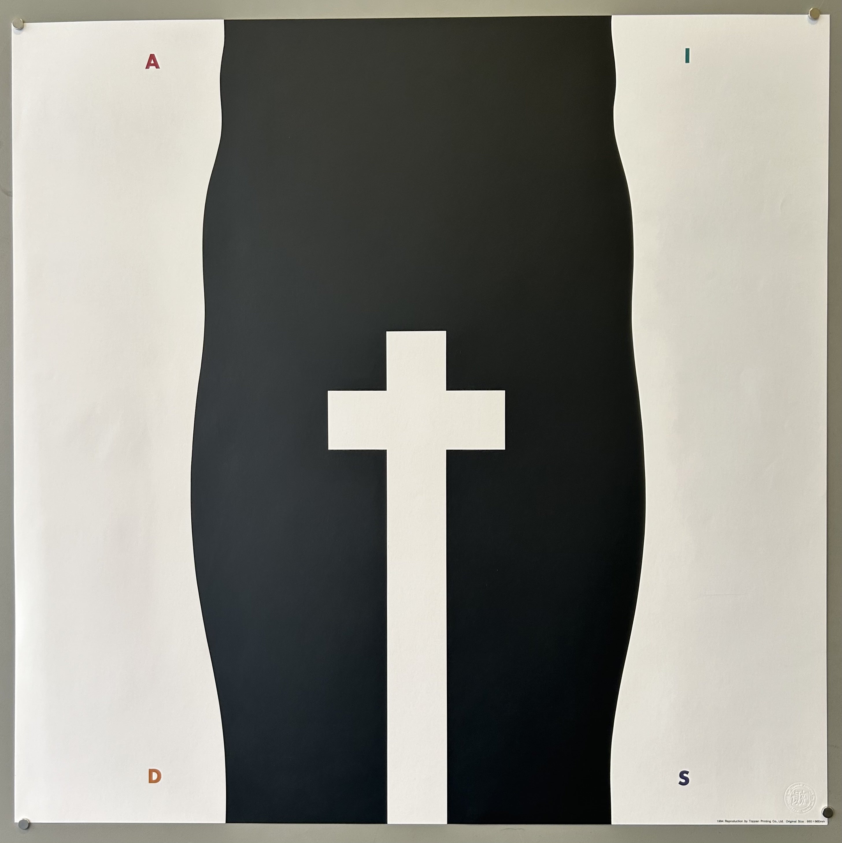 Black legs with a cross in the middle of them to symbolize the AIDS crisis, with A, I, D, and S all positioned in each of the four corners.