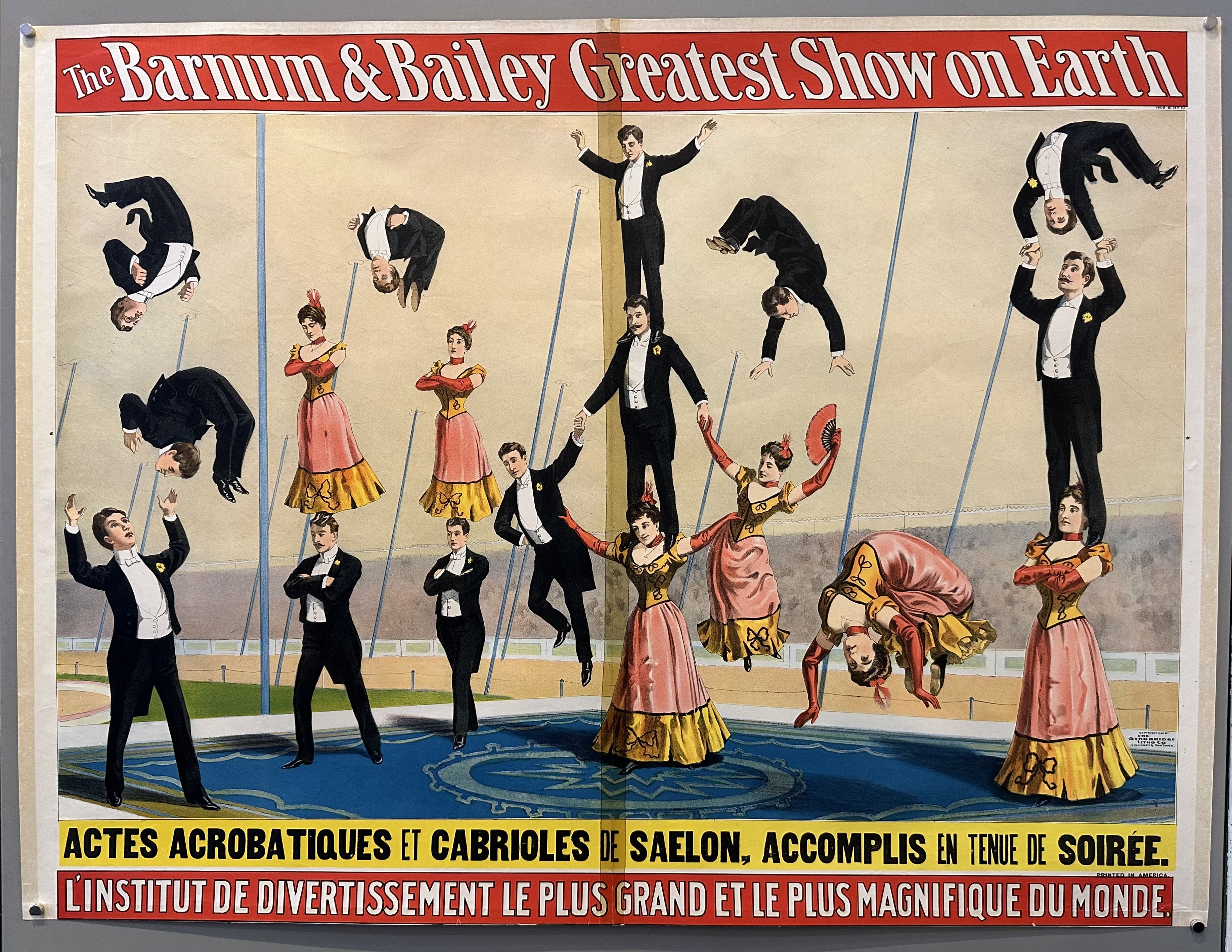 A vintage poster for the Barnum & Bailey Greatest Show on Earth featuring acrobats performing a human pyramid act. The French text reads: "8 acrobatic and tumbling acts by Saelon, performed in evening dress. The largest and most magnificent entertainment institute in the world.".