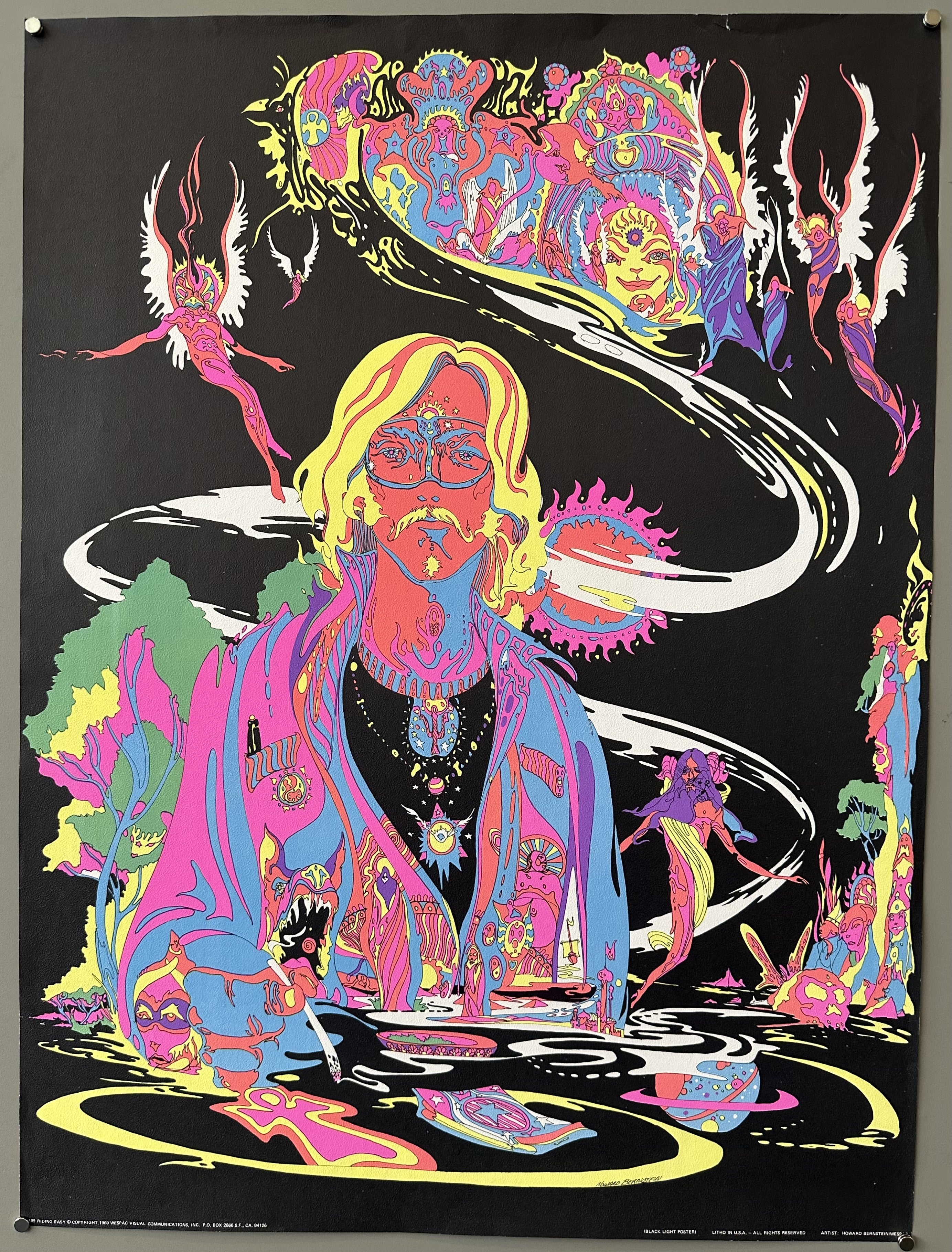 Black background with colorful psychedelic design of a man and many fairy-like creatures.