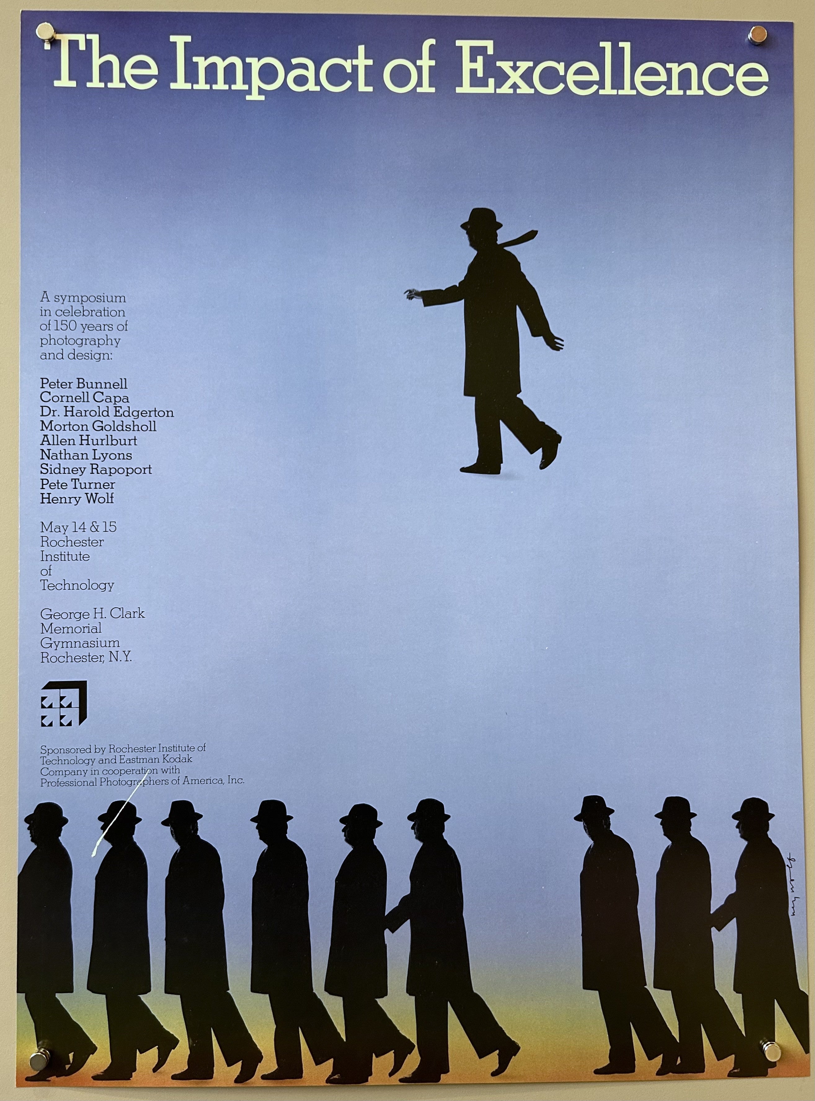 A large silhouette of a man in a hat and coat is shown in the center of the poster. A row of multiple identical silhouettes of men in hats and coats, all walking in the same direction, is shown along the bottom edge of the poster, which has a yellow and orange striped background.