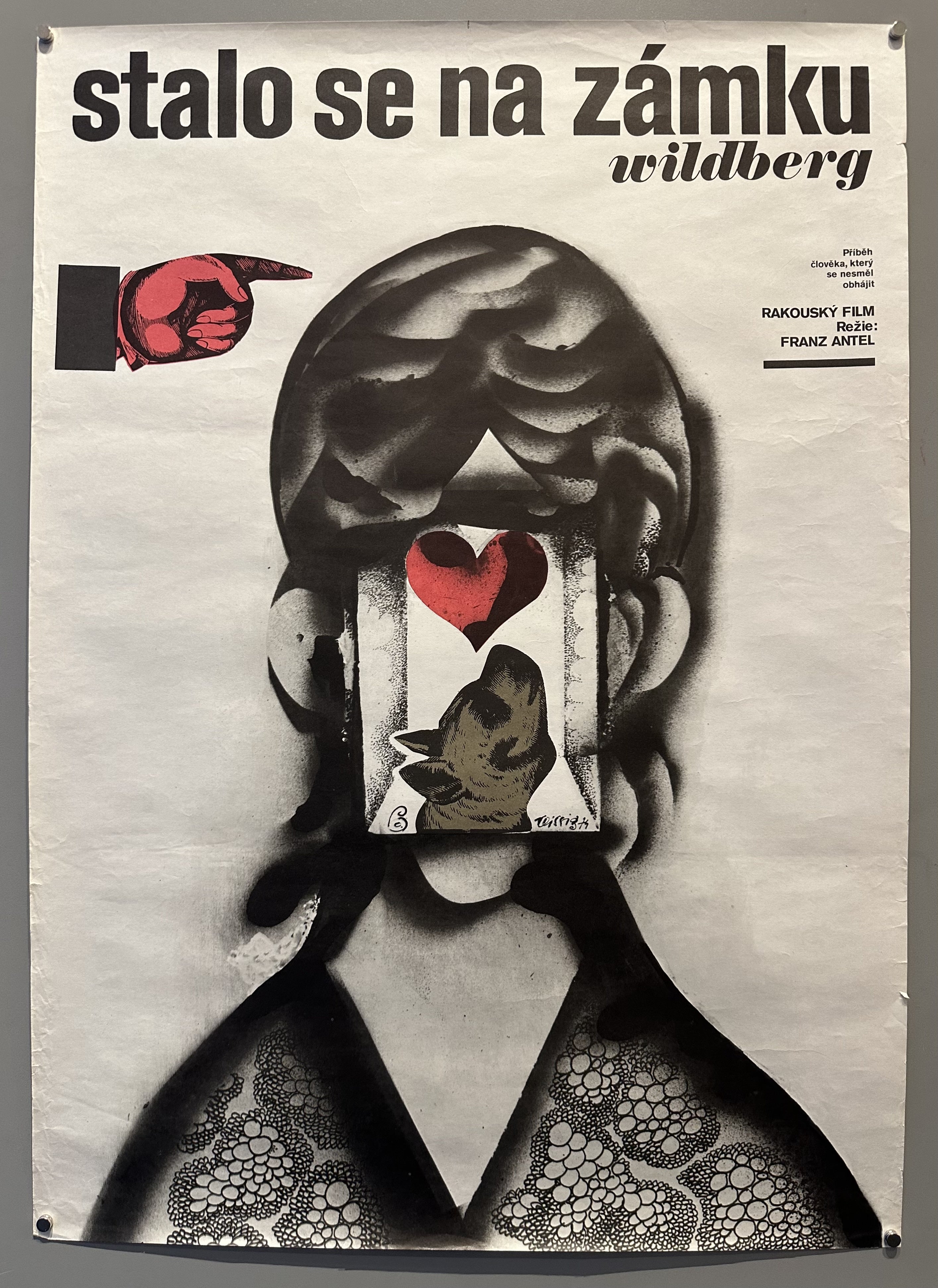 A poster for the Austrian film "Stalo se na zámku Wildberg" (What Happened at Wildberg Castle) directed by Franz Antel. The poster features a pointing hand and a stylized face with a heart.