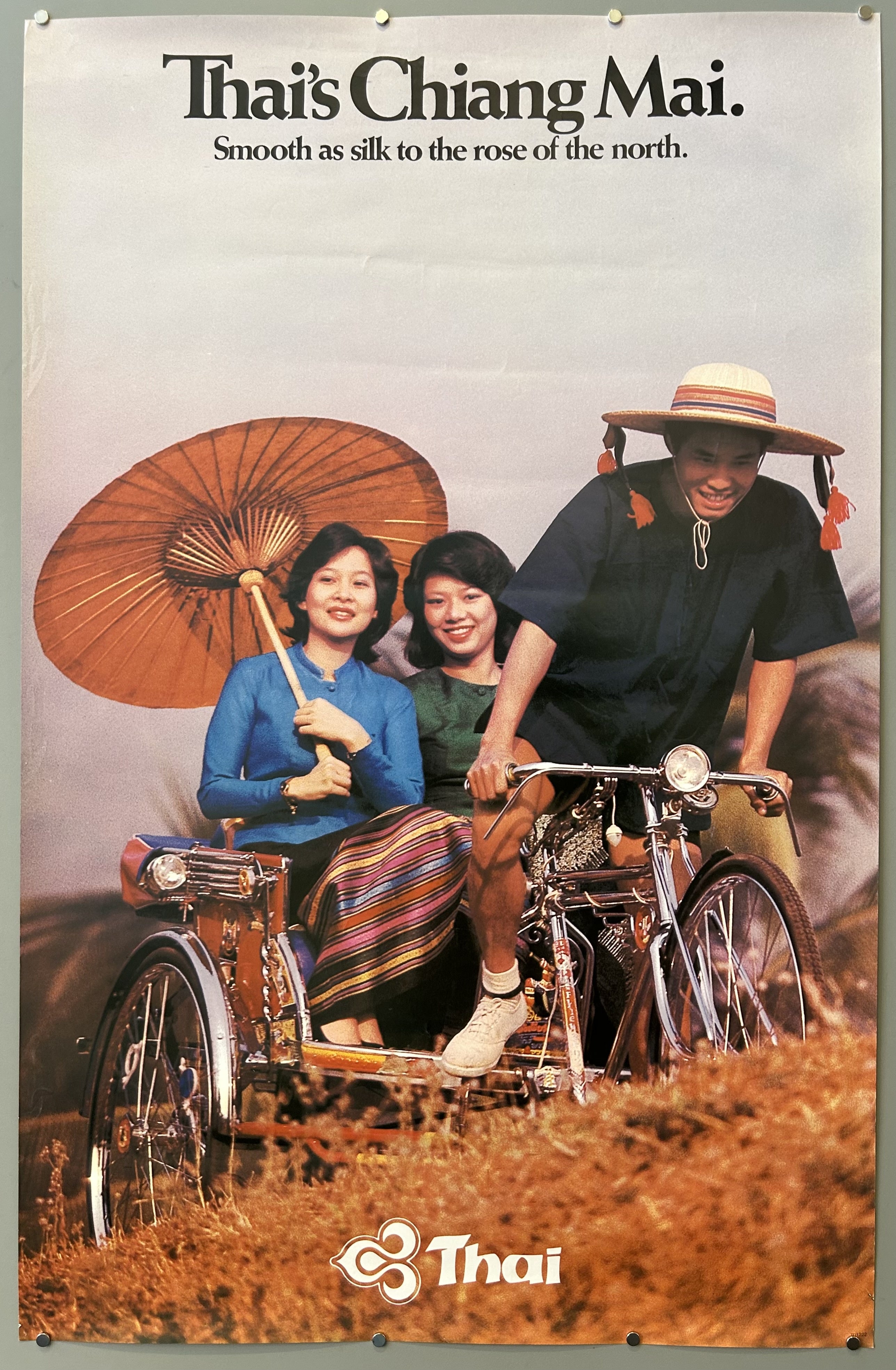 Photograph of Thai locals in Chiang Mai in vintage travel poster from Thai Airways, text located along top and along bottom.
