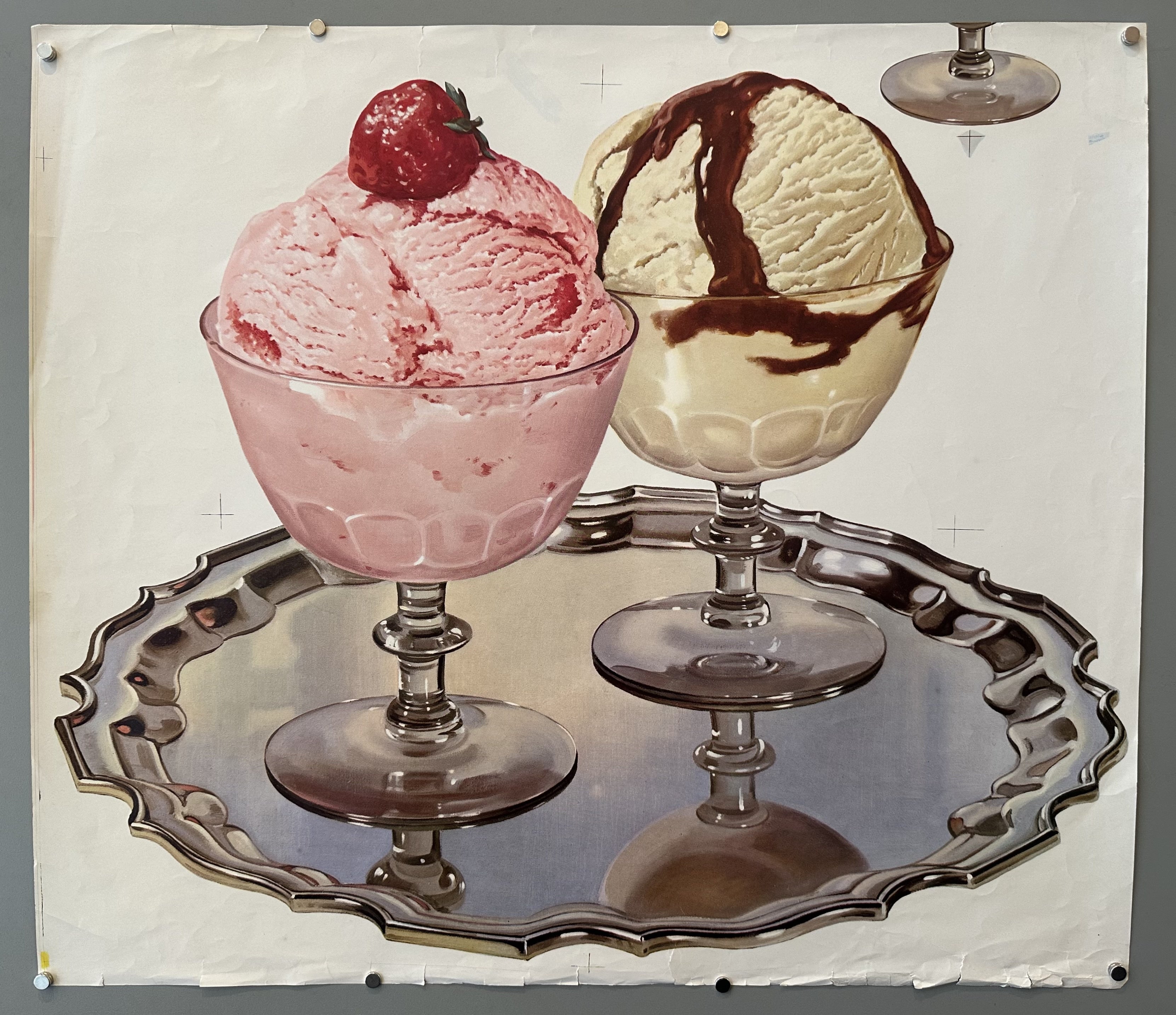Plain white background with strawberry and vanilla ice cream scoops in separate glasses on a metal tray.