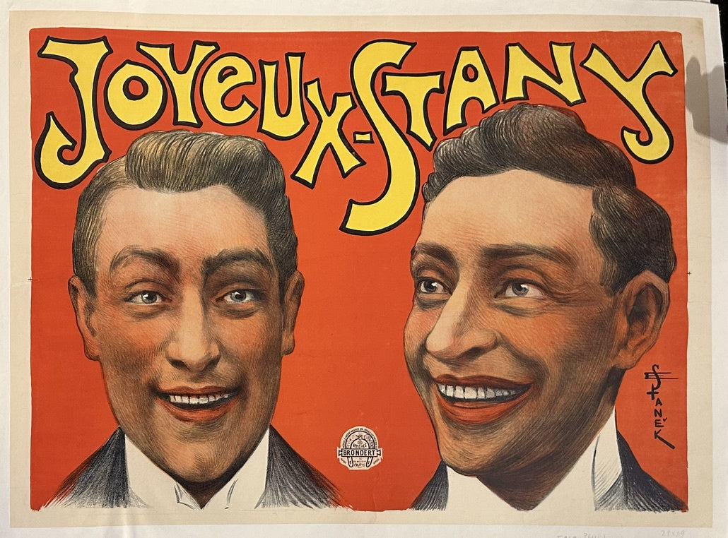 The poster depicts "Joyeux-Stany," featuring two smiling male figures, and was created by artist Emanuel V. Stanek (1852-1920).
