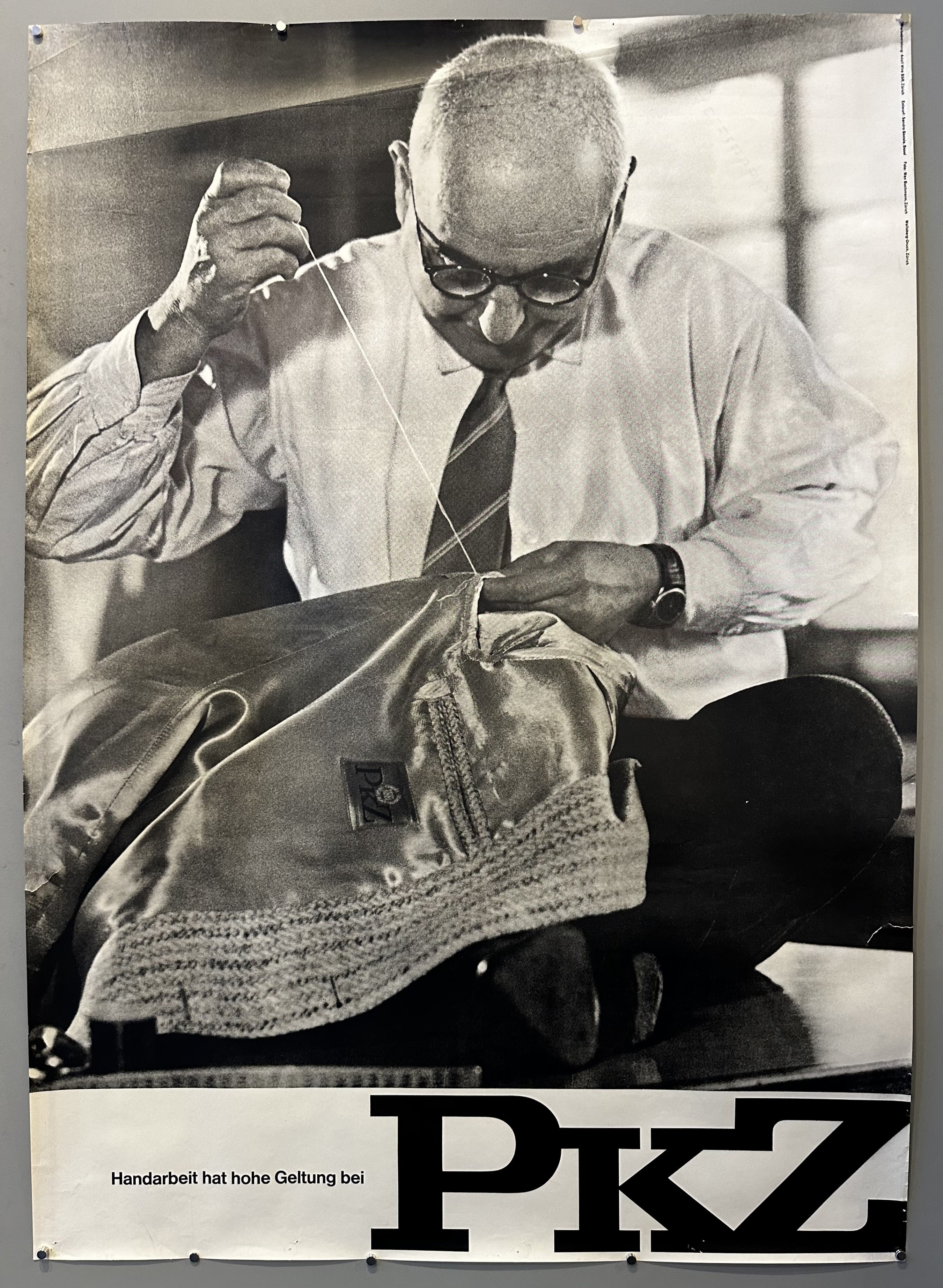 Photograph of a man sewing a garment in vintage advertisement for PKZ.