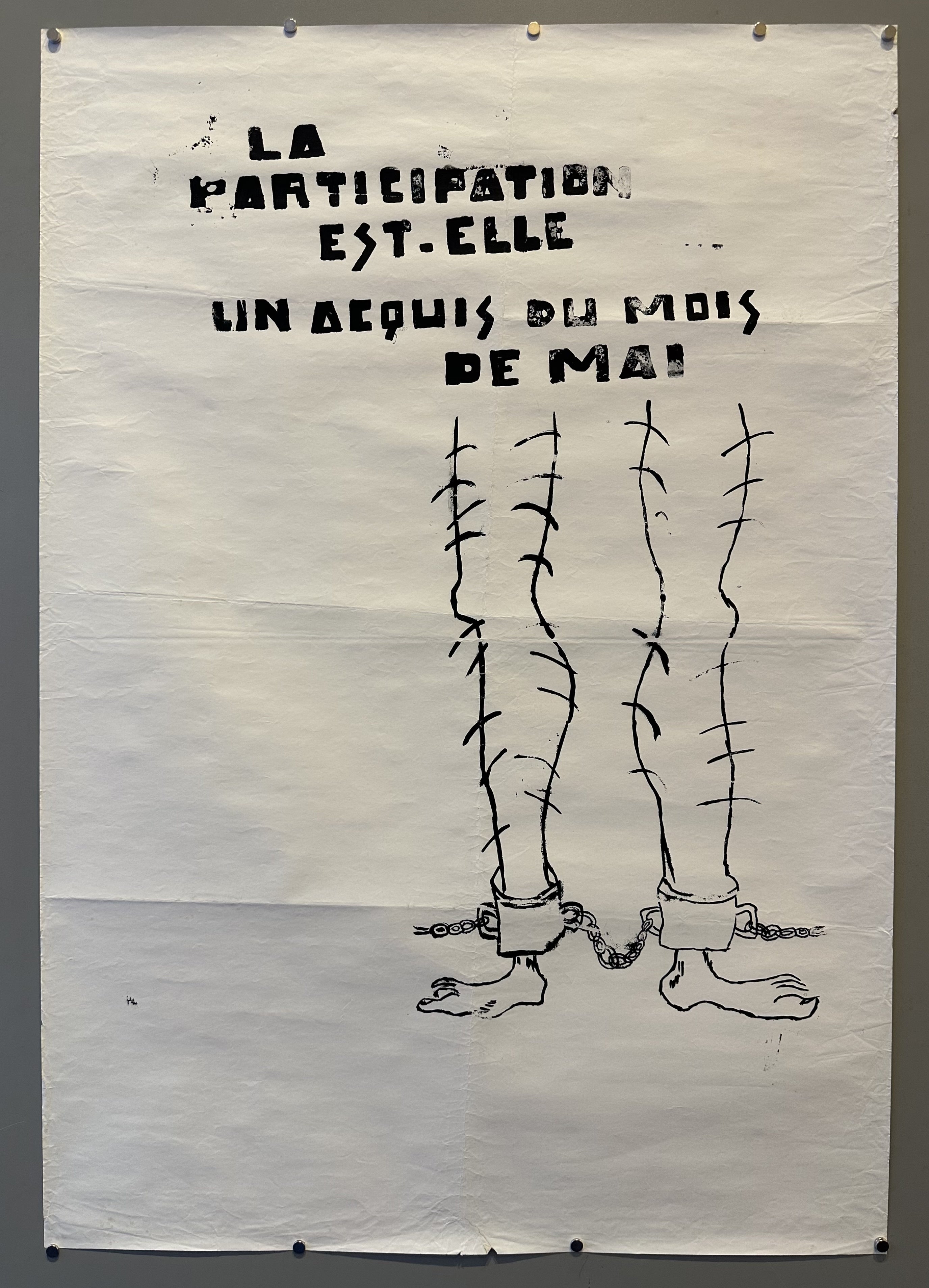 A pair of hairy legs with shackles on them peek out in this poster for May 68.