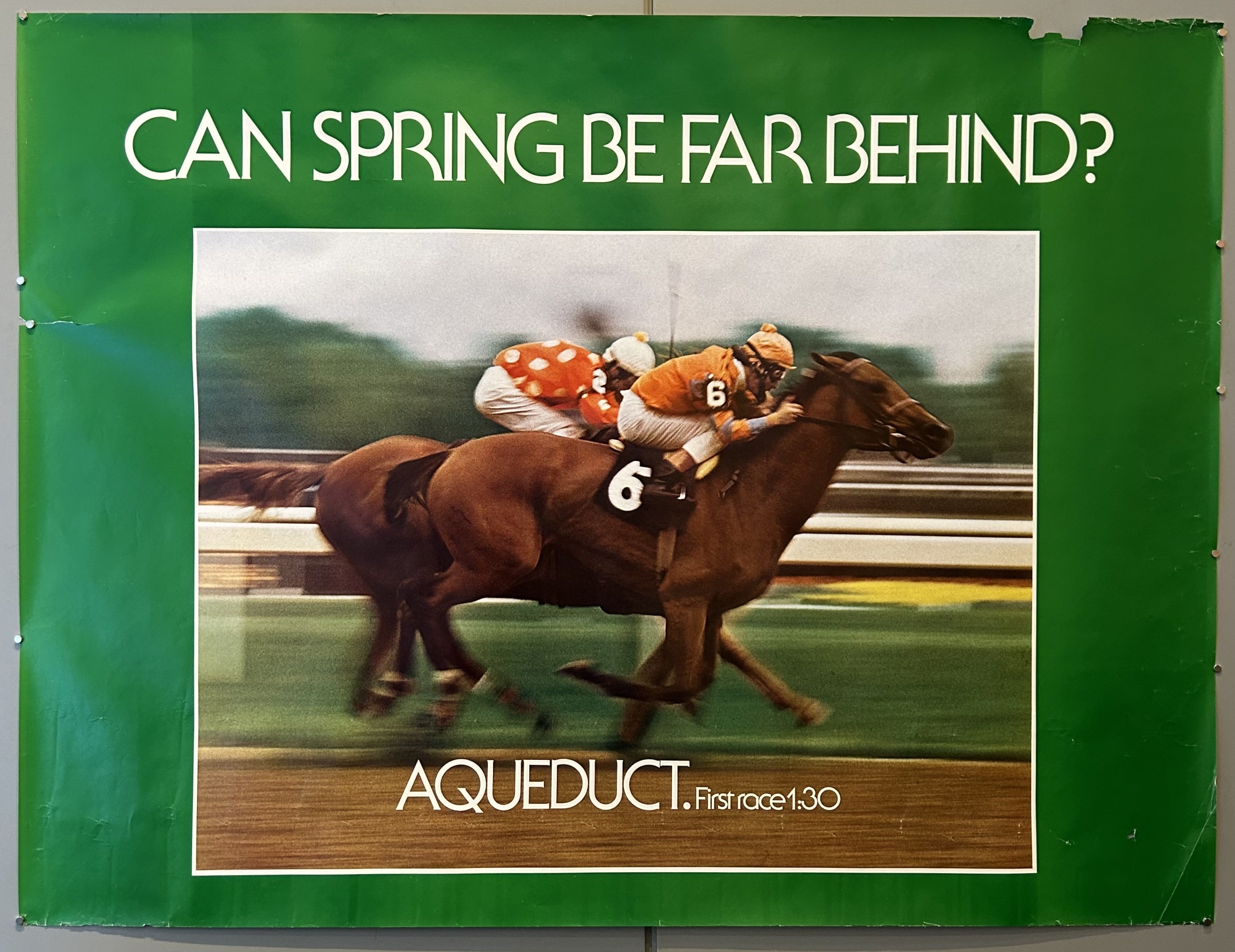 The phrase "CAN SPRING BE FAR BEHIND?" suggests a connection between the arrival of spring and the start of the racing season or a particular event at Aqueduct