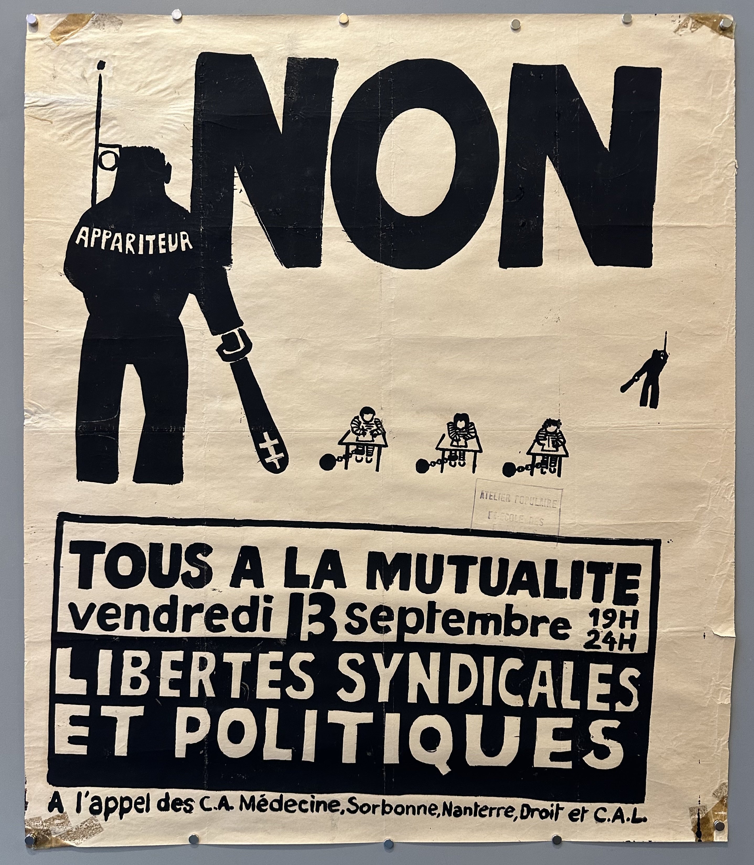 A bailiff stands over students in chains at desks in this French May 68 political protest poster.