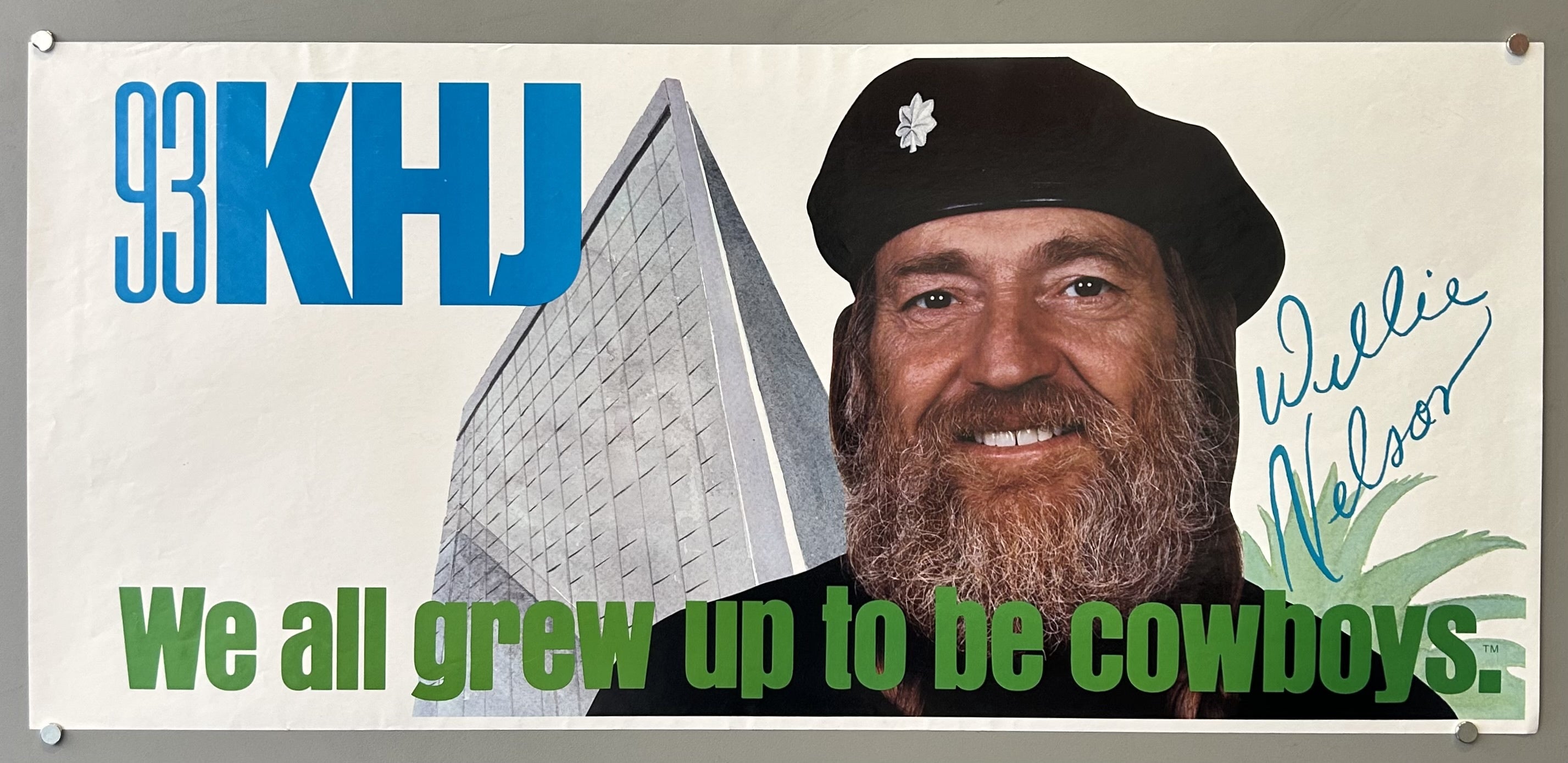 Radio station advertisement with a photograph of Willie Nelson and a building behind him.