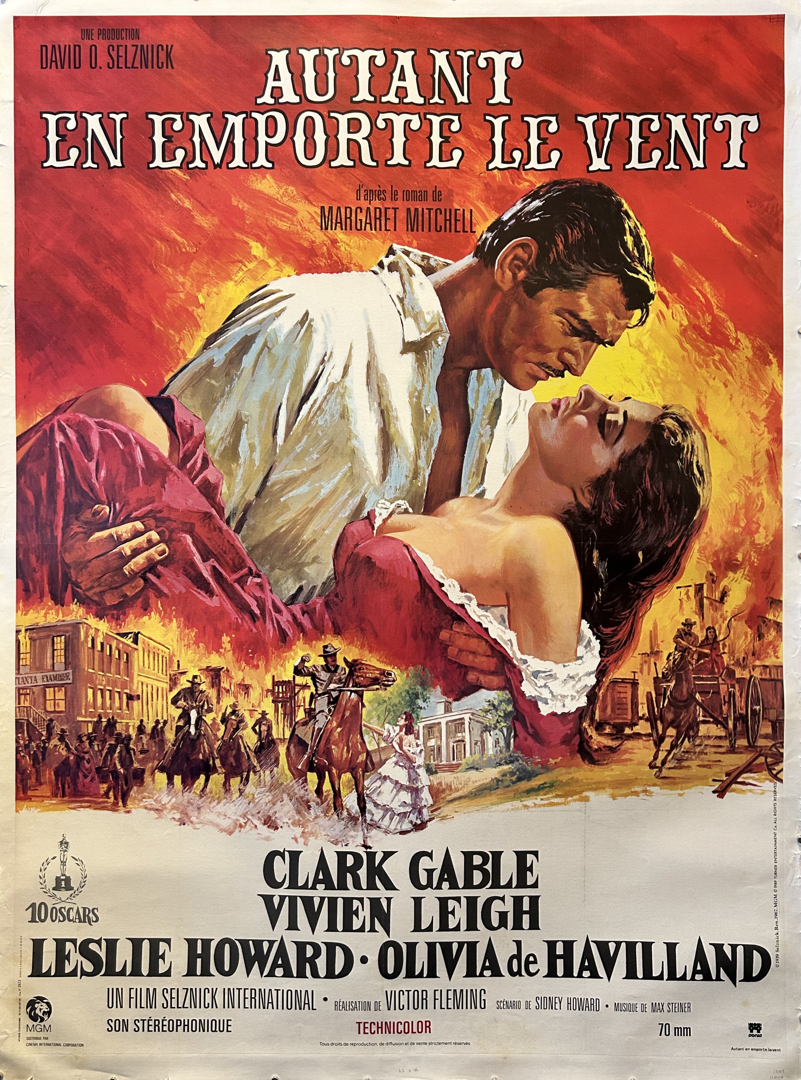 French release poster for 'Gone with the Wind' featuring illustrated Scarlett O'Hara and Rhett Butler in an embrace with black text below