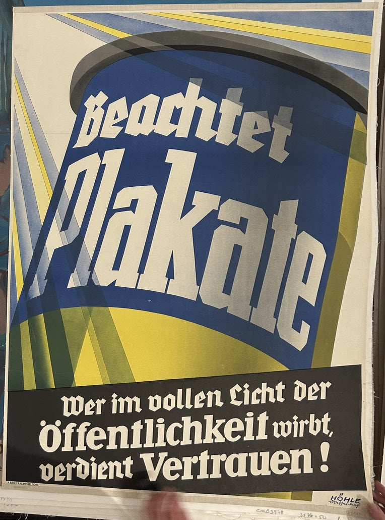 The minimalist design, bold typography, and focus on a central, simplified image (the large can/container) are characteristic features of Plakatstil, a German poster art movement that emerged in the early 20th century. The style emphasizes clear communication through strong visual elements and minimal text, aiming for immediate impact.
