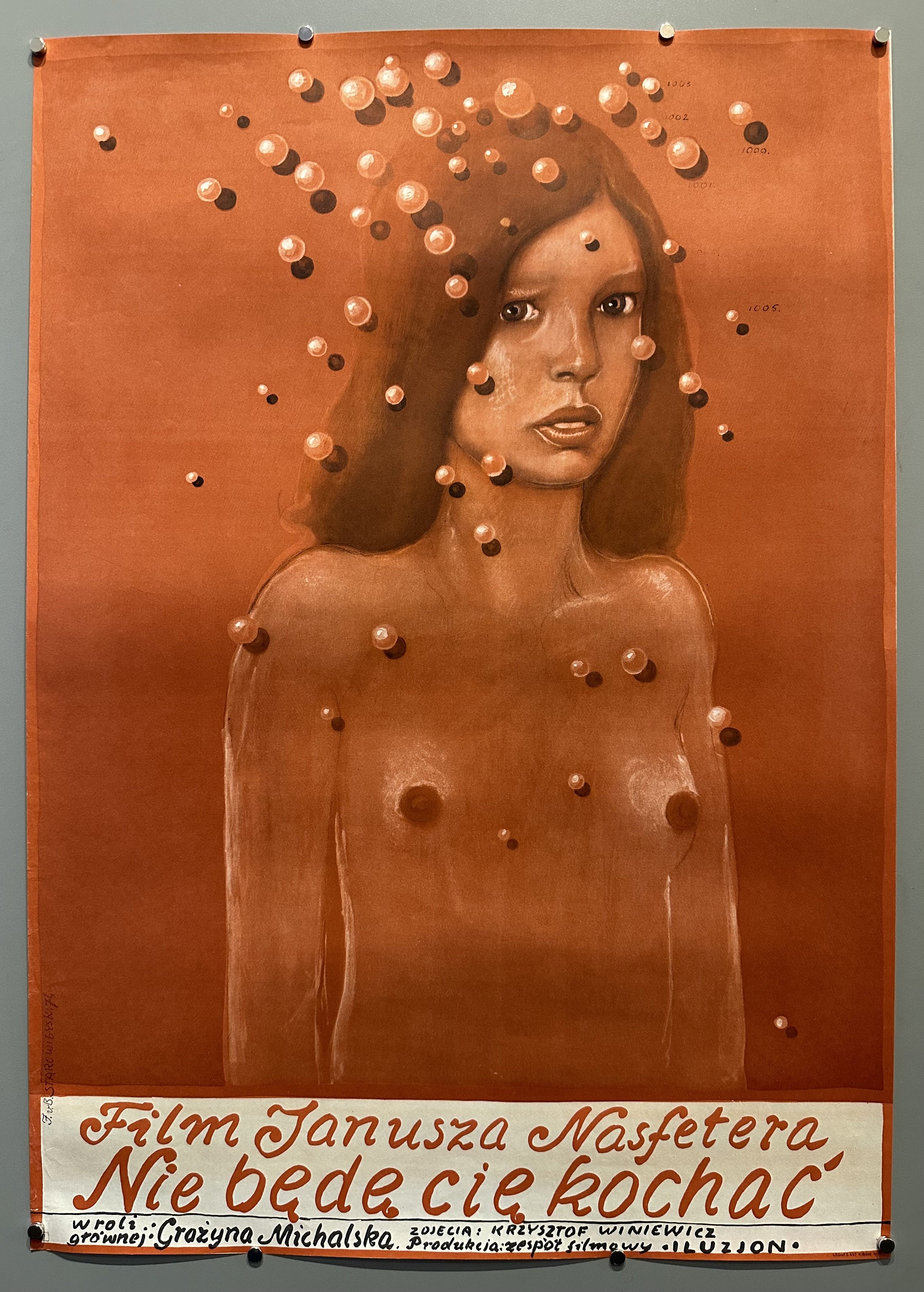 A advertisement poster for the film "I Wont Love You" by Janusz Nasfeter with a nude brunette and pearl like shapes hovering over her. The text underneath is polish translating into the name of the film and the co-stars.