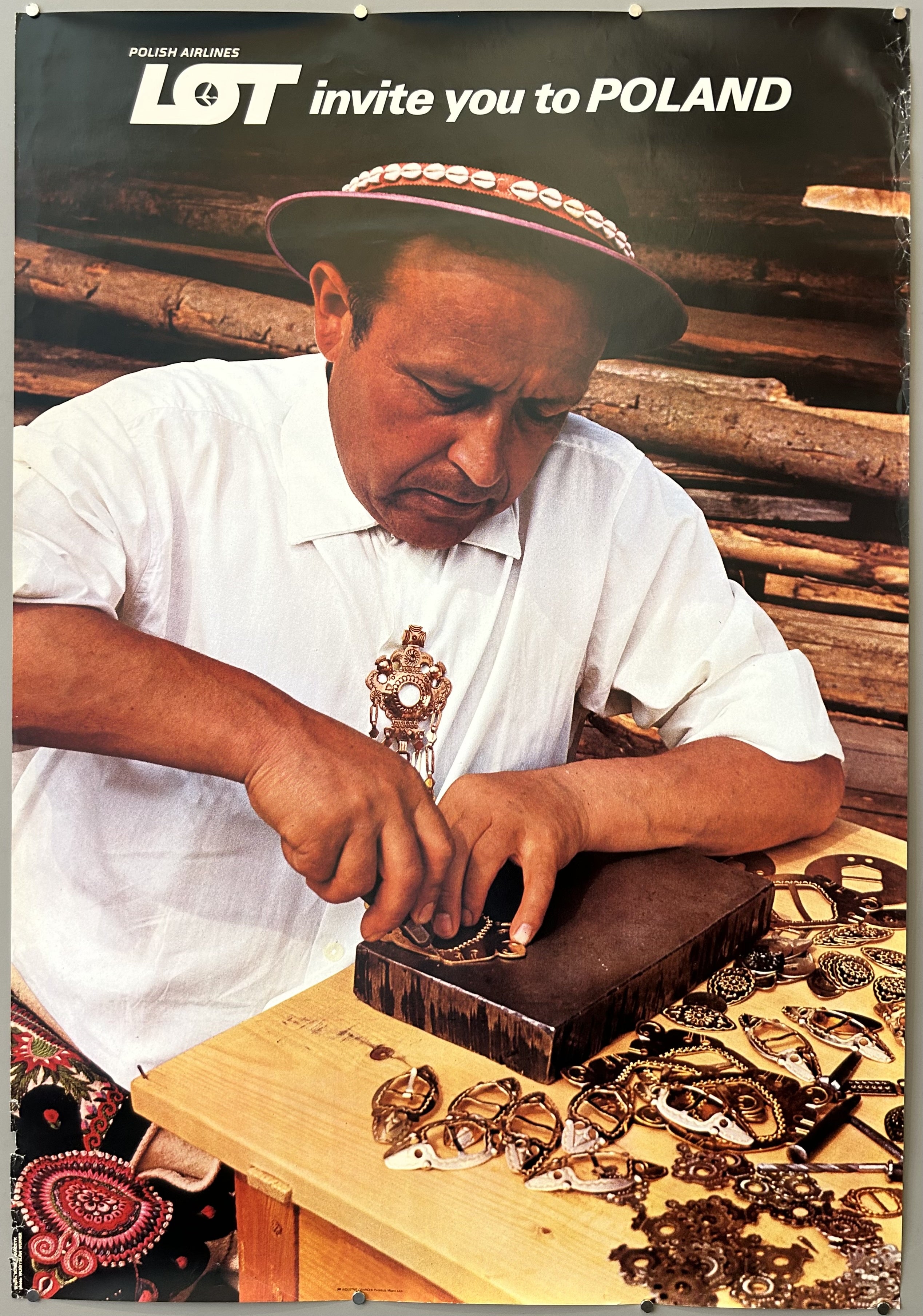 Photograph of man carving traditional folk pins in Polish Airlines poster.