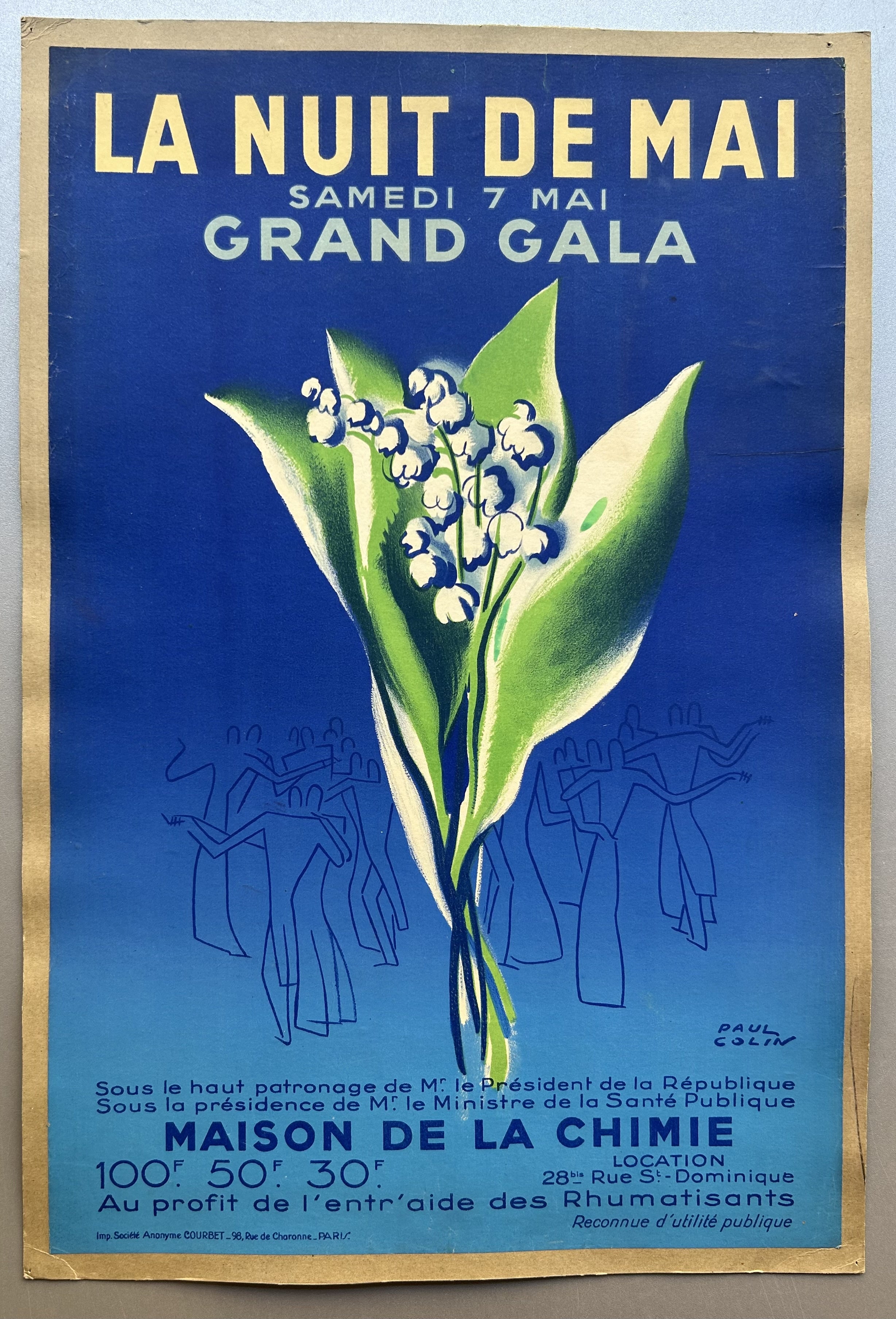 Blue poster with green floral arrangement in middle in front of silhouettes of people dancing by Paul Colin to promote a gala.
