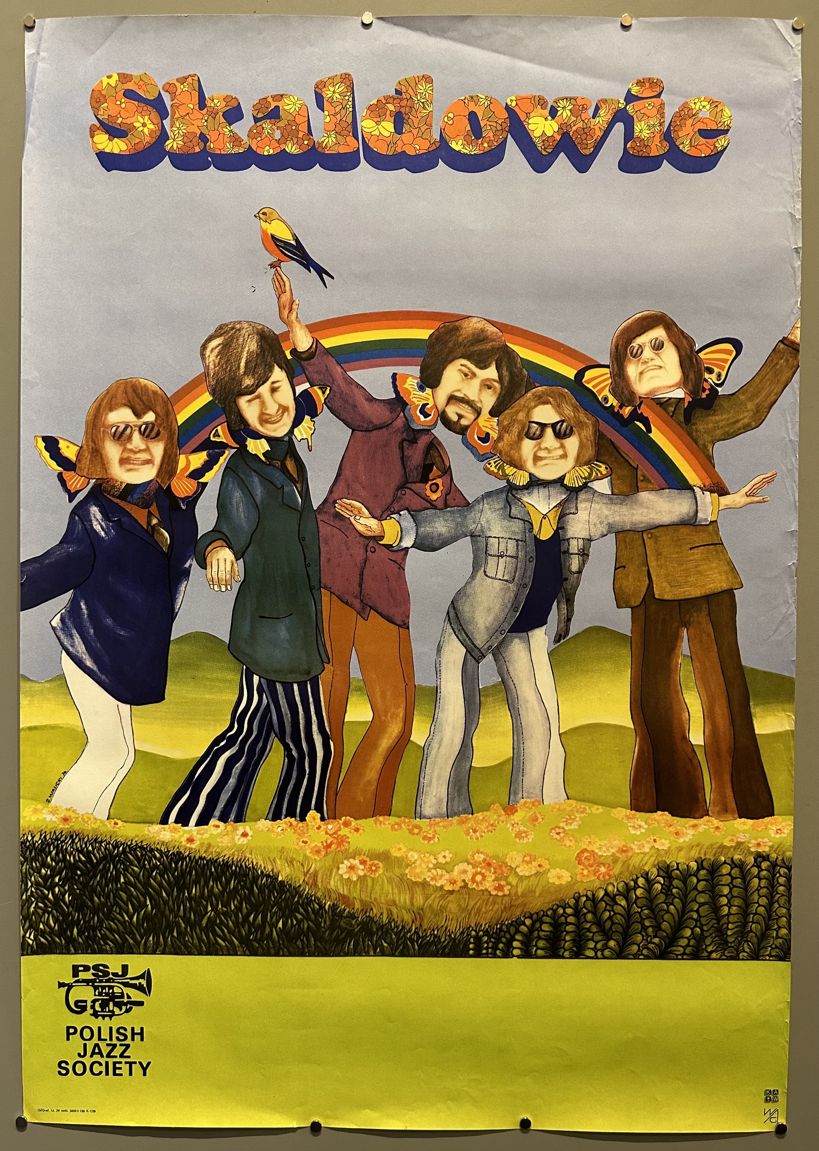 Five men are drawn in psychedelic style posing with a rainbow in a field of flowers.