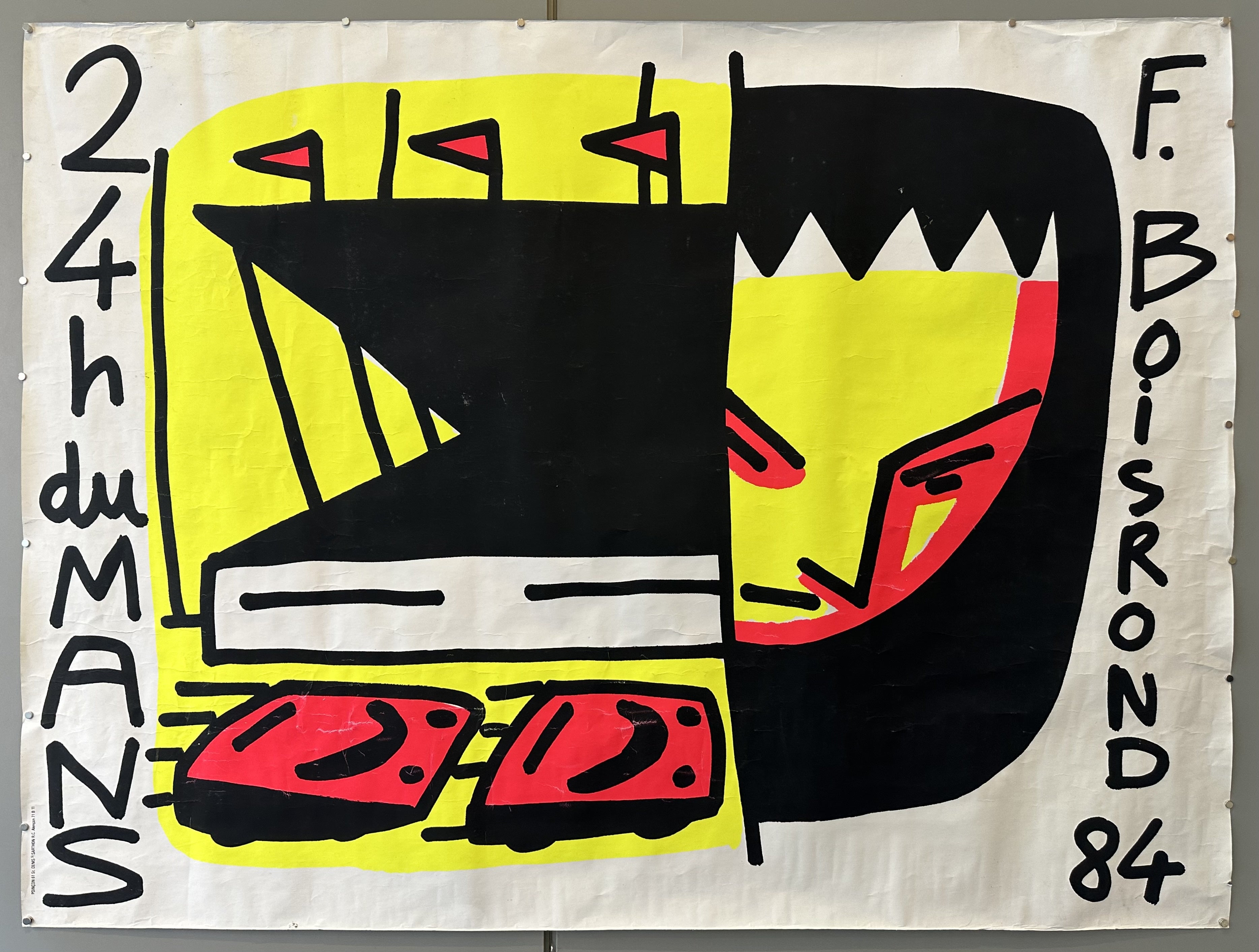 Haring and Boisrond designed poster for 24h du Mans of a black, yellow, and red abstract figure racing a car.