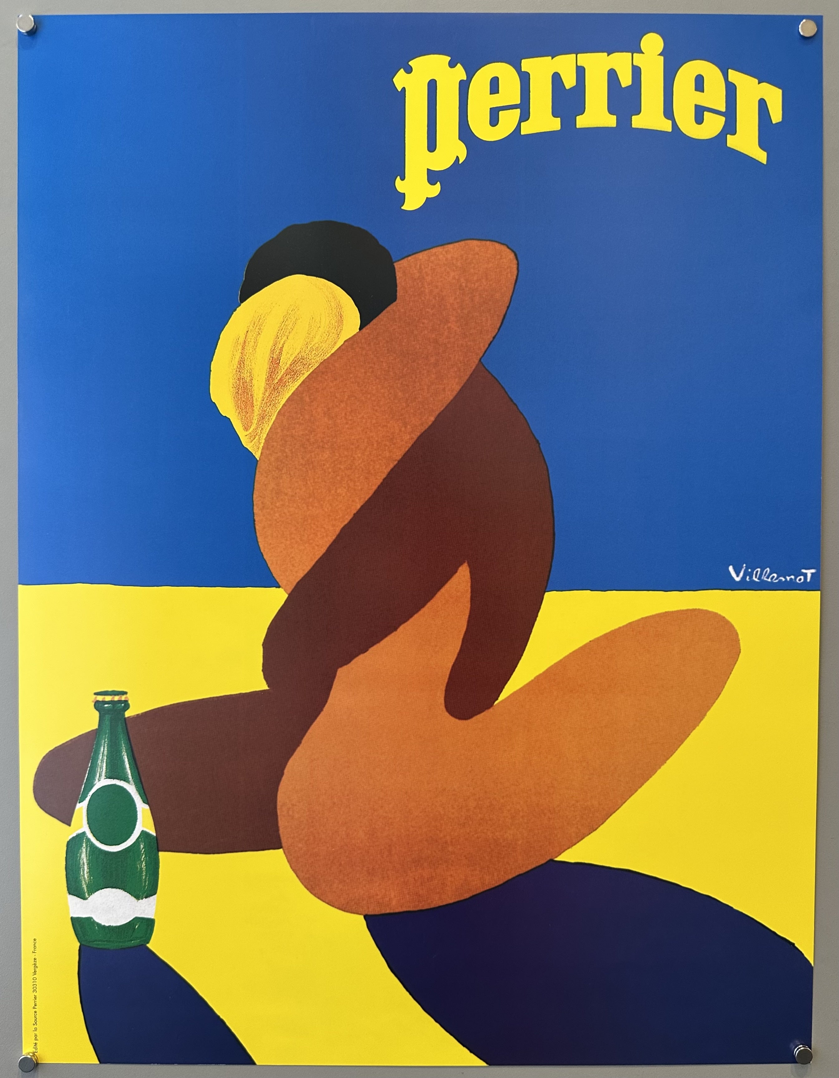 Poster with illustration of a couple on a beach against yellow sand and blue sky with yellow Perrier logo above them.