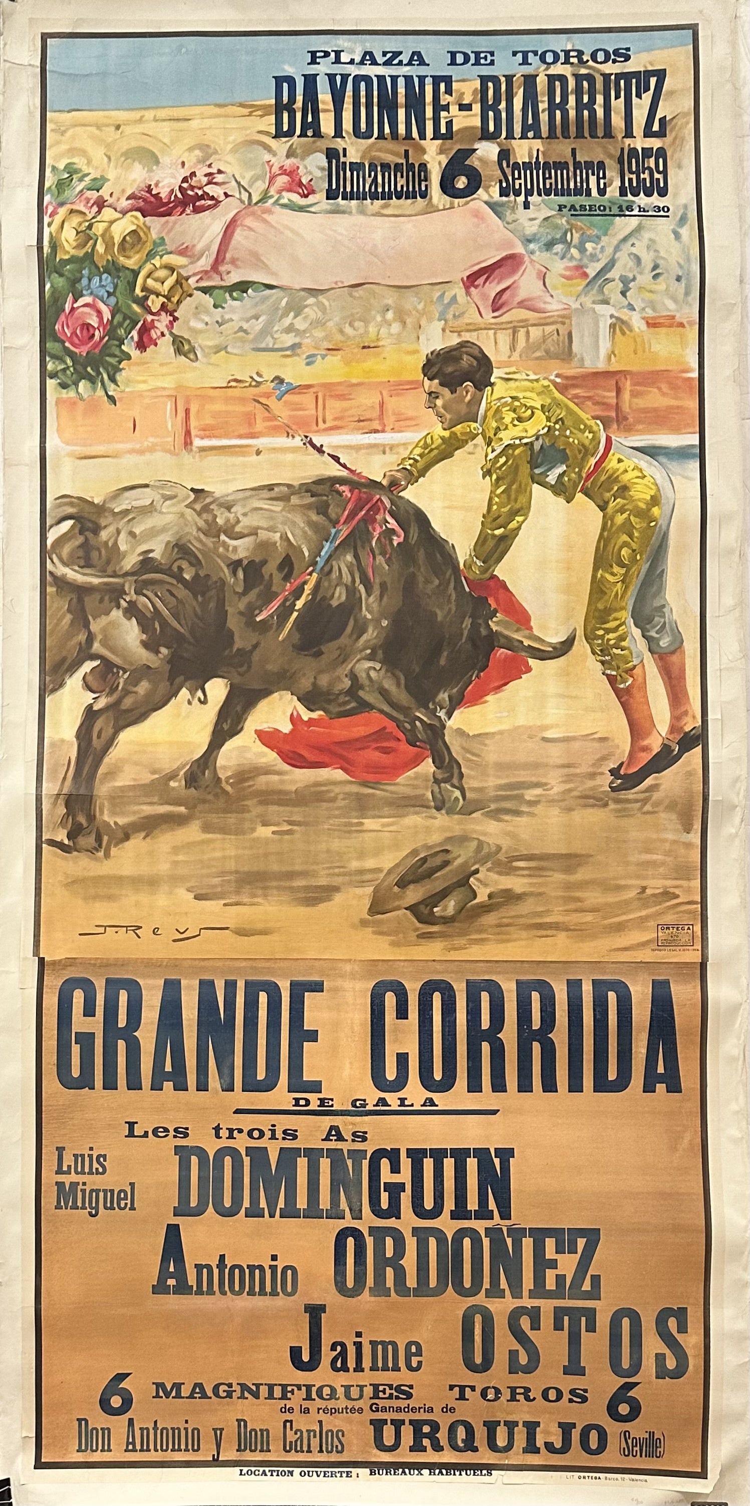 A torero tames a bull in a bullfighting ring.