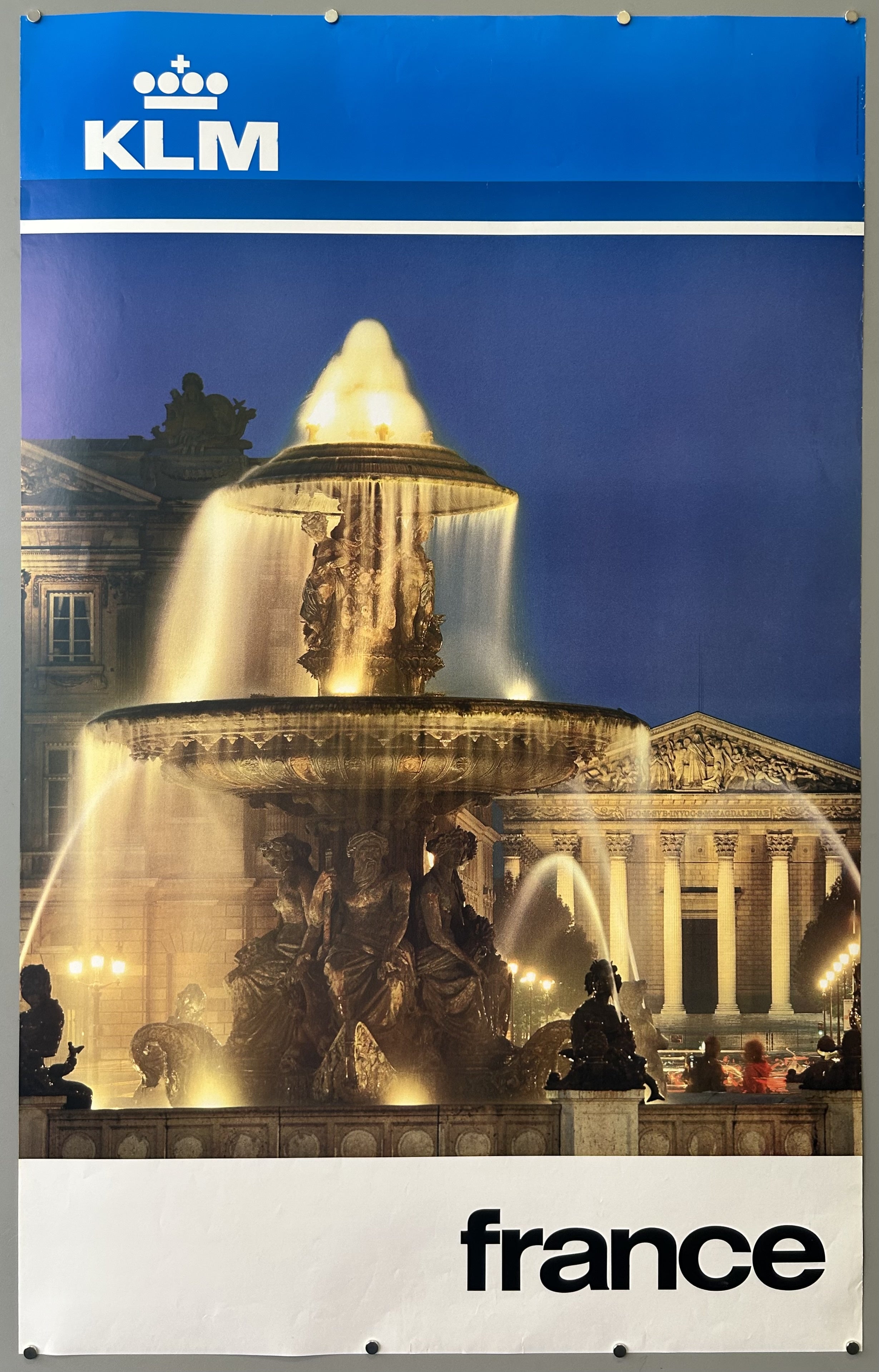 Photograph of a fountain at night in Paris, France in vintage travel poster from KLM.