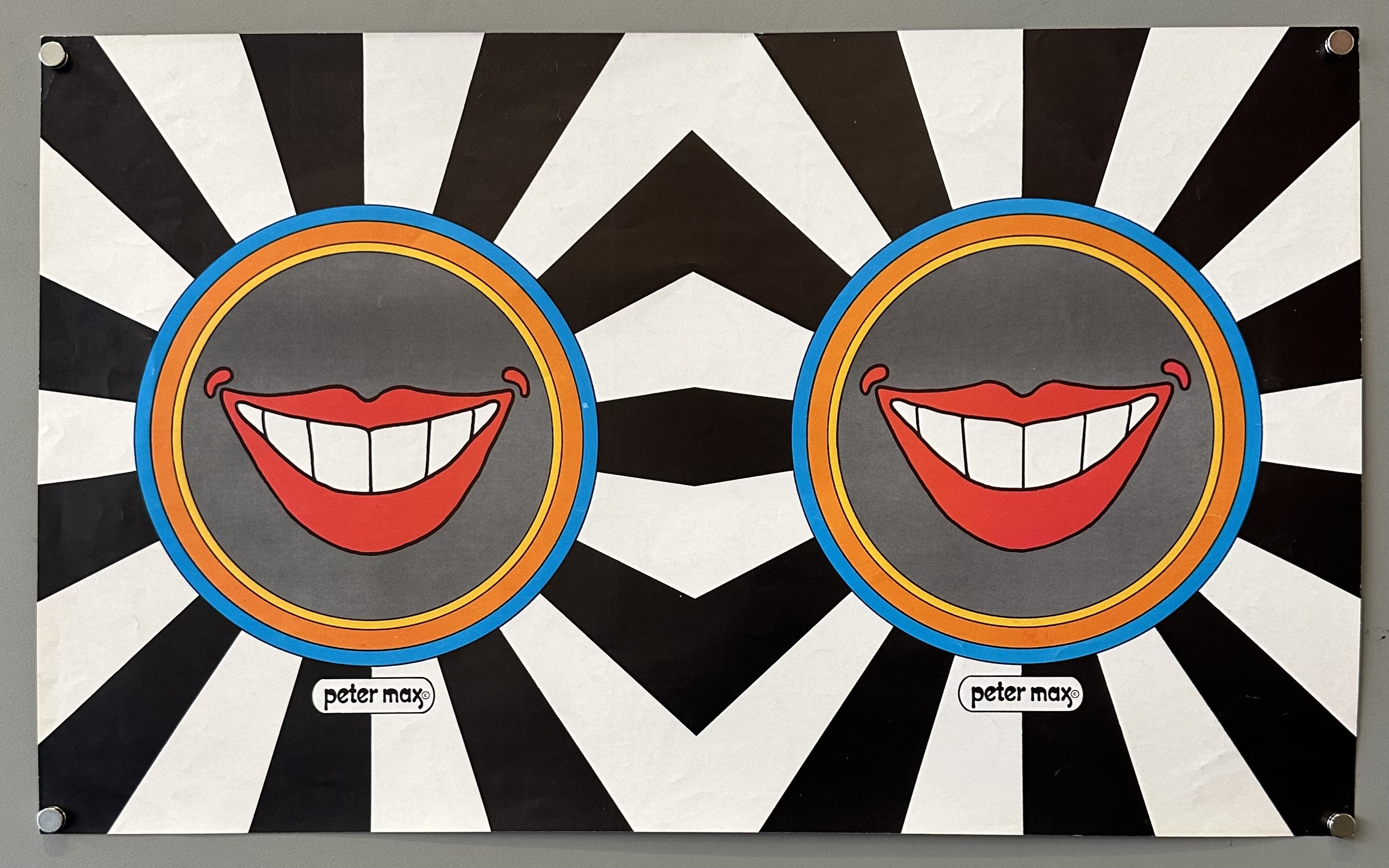 Black and white poster with red lips smiling in the middle, mirrored in the middle by Peter Max for Capitol Records.
