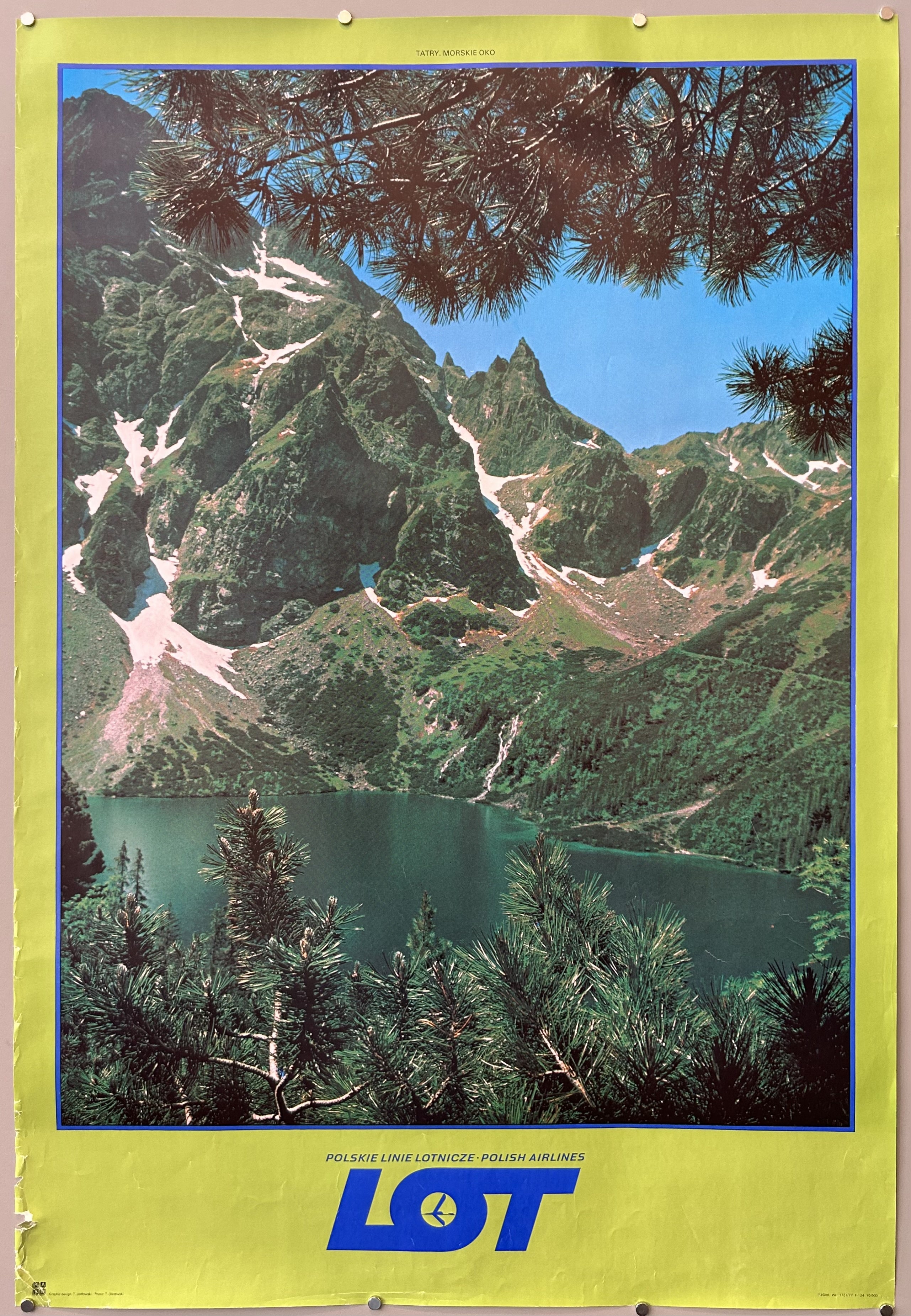 Photograph of a mountain range with bright green border in vintage airline poster.
