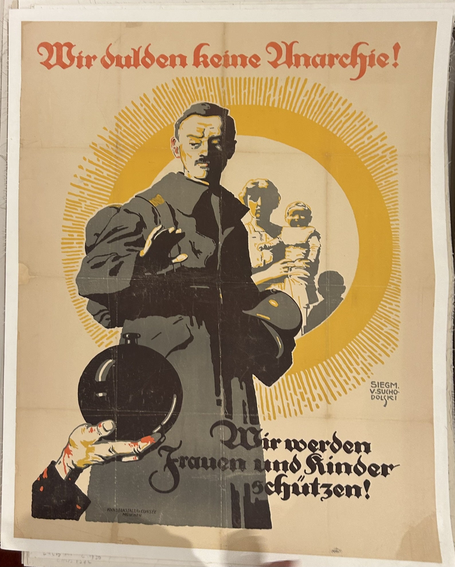 It depicts a soldier standing protectively in front of a woman and her children, with a bloody hand holding a bomb in the lower-left corner, symbolizing the dangers of anarchy.