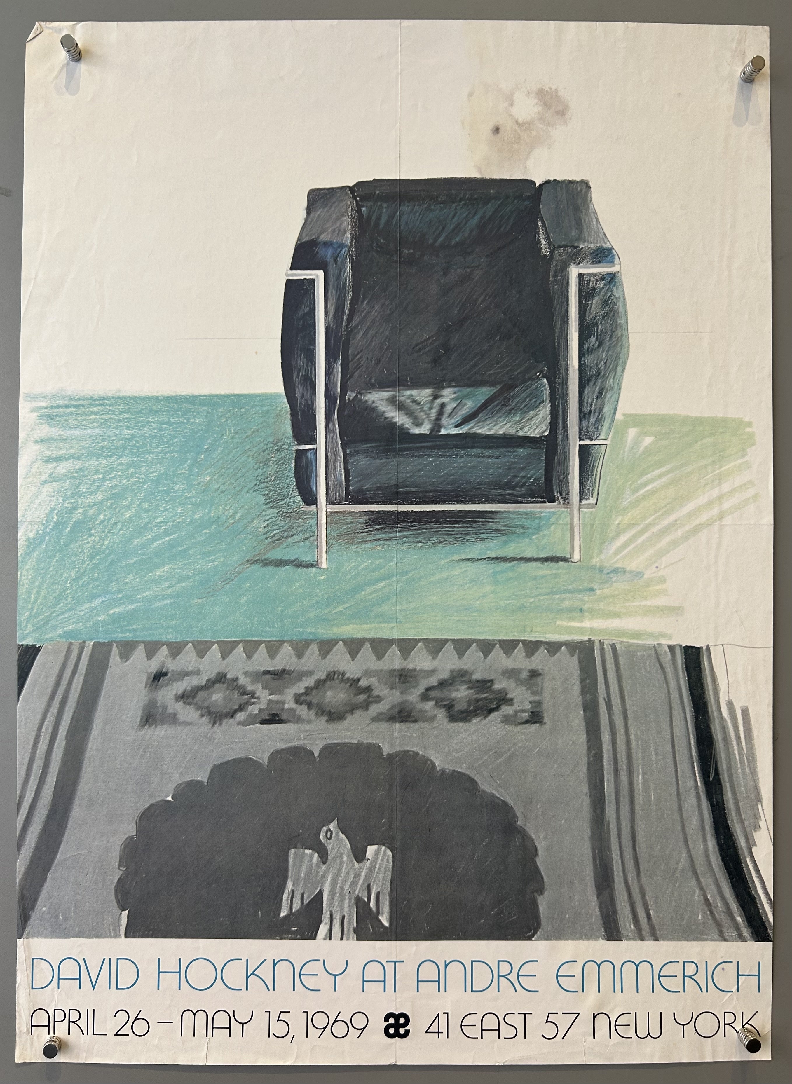 Drawing of a chair on a teal floor with a grey rug above white bar with blue and black text inside.